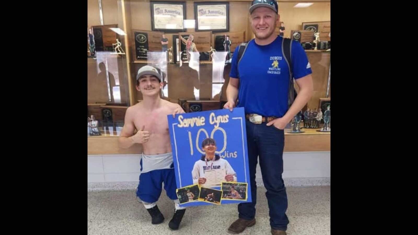 Sammie Cyrus, a senior at Dubois High School, with wrestling coach Brock Baker.