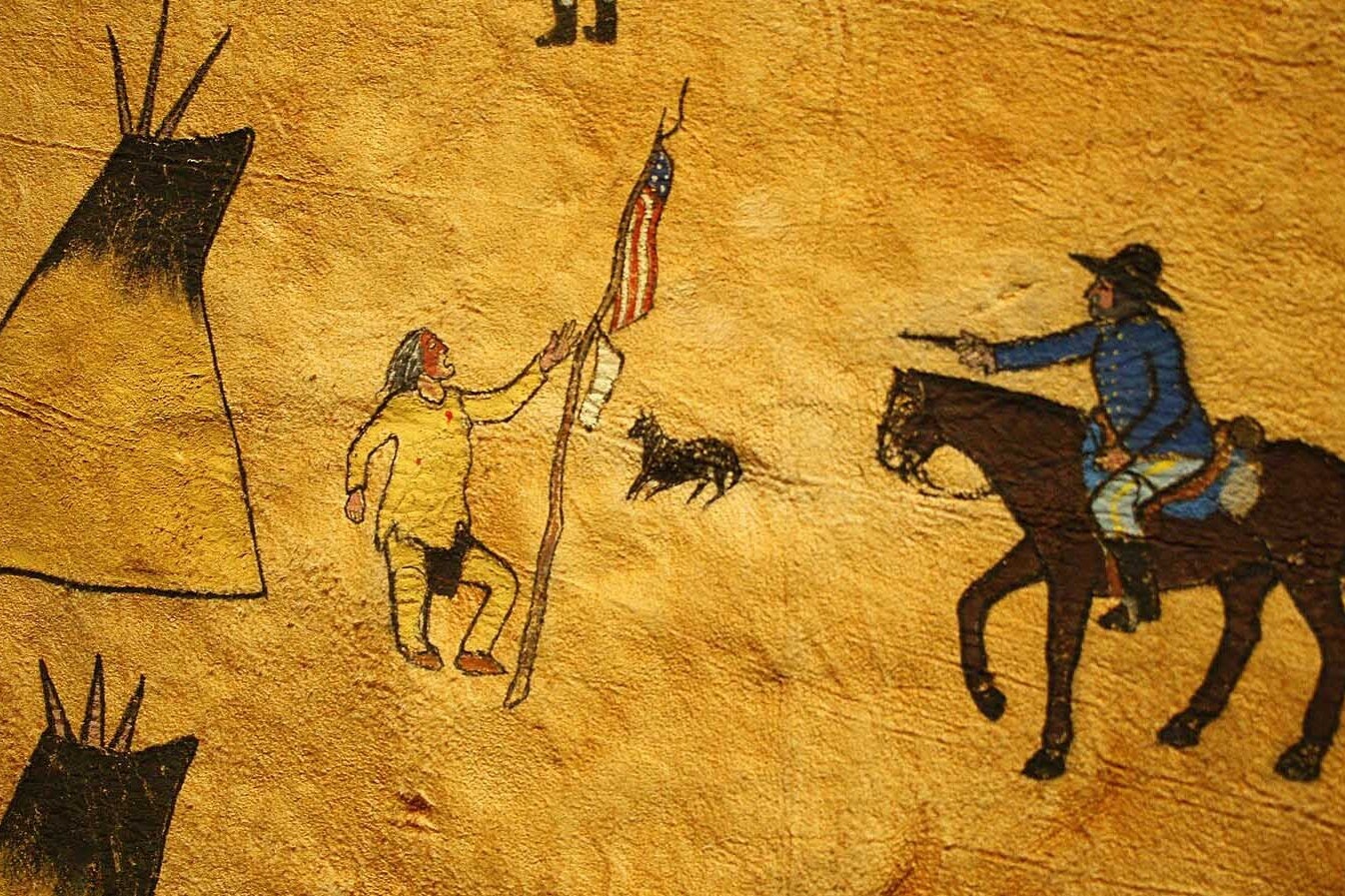 The photo is a piece of a painting on an elk hide showing Black Kettle with the American Flag and the military attack at Sand Creek. The hide was painted by Northern Arapaho Benjamin Ridgely Sr. The original is on display at the Northern Arapaho Experience Room in the Wind River Hotel and Casino just west of Riverton.
