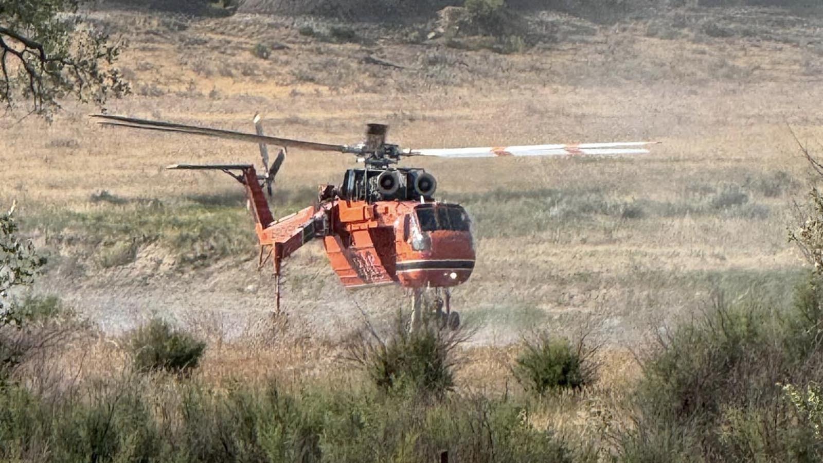 A helicopter picks up water to drop on the Silver Spoon Fire in northern Campell County, Wyoming, near the Montana border.