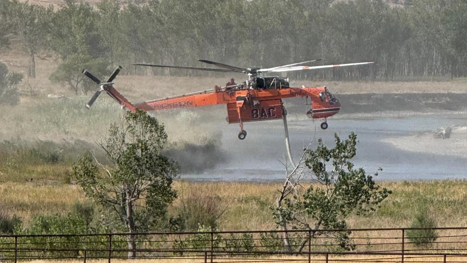 A helicopter picks up water to drop on the Silver Spoon Fire in northern Campell County, Wyoming, near the Montana border.