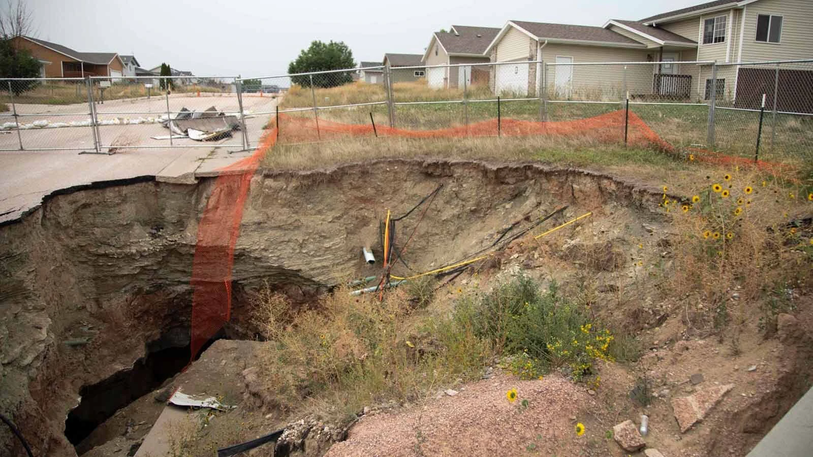 Six years after a huge sinkhole opened up in a subdivision near Black Hawk, South Dakota, victims still waiting for relief. The disaster highlights the difference between Wyoming’s abandoned mine safeguards and South Dakota’s limited protections.