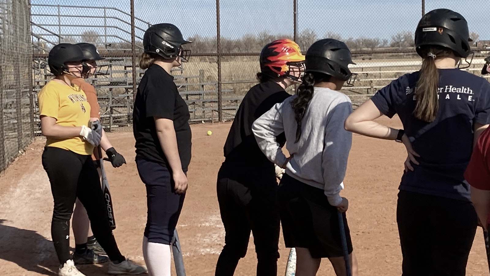High school softball players from Riverton, Shoshoni and Lander enjoy a warm spring day Monday to practice outside with the Worland High team.