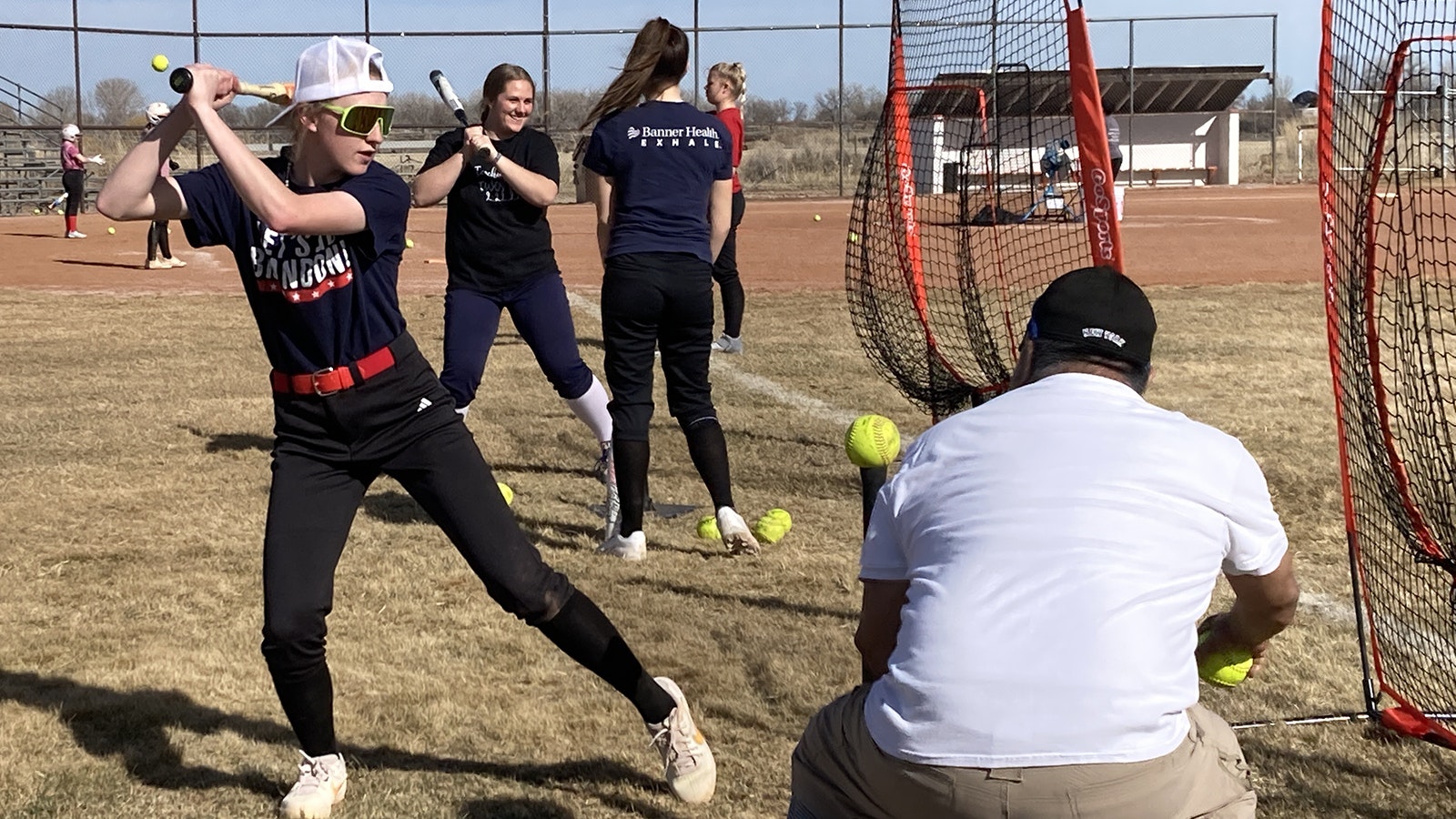 Riverton High School senior Cassy Miller practices Monday with the World High girls softball team. Miller and 12 other players from Riverton, Shoshoni and Lander travel three hours every day to be part of the team