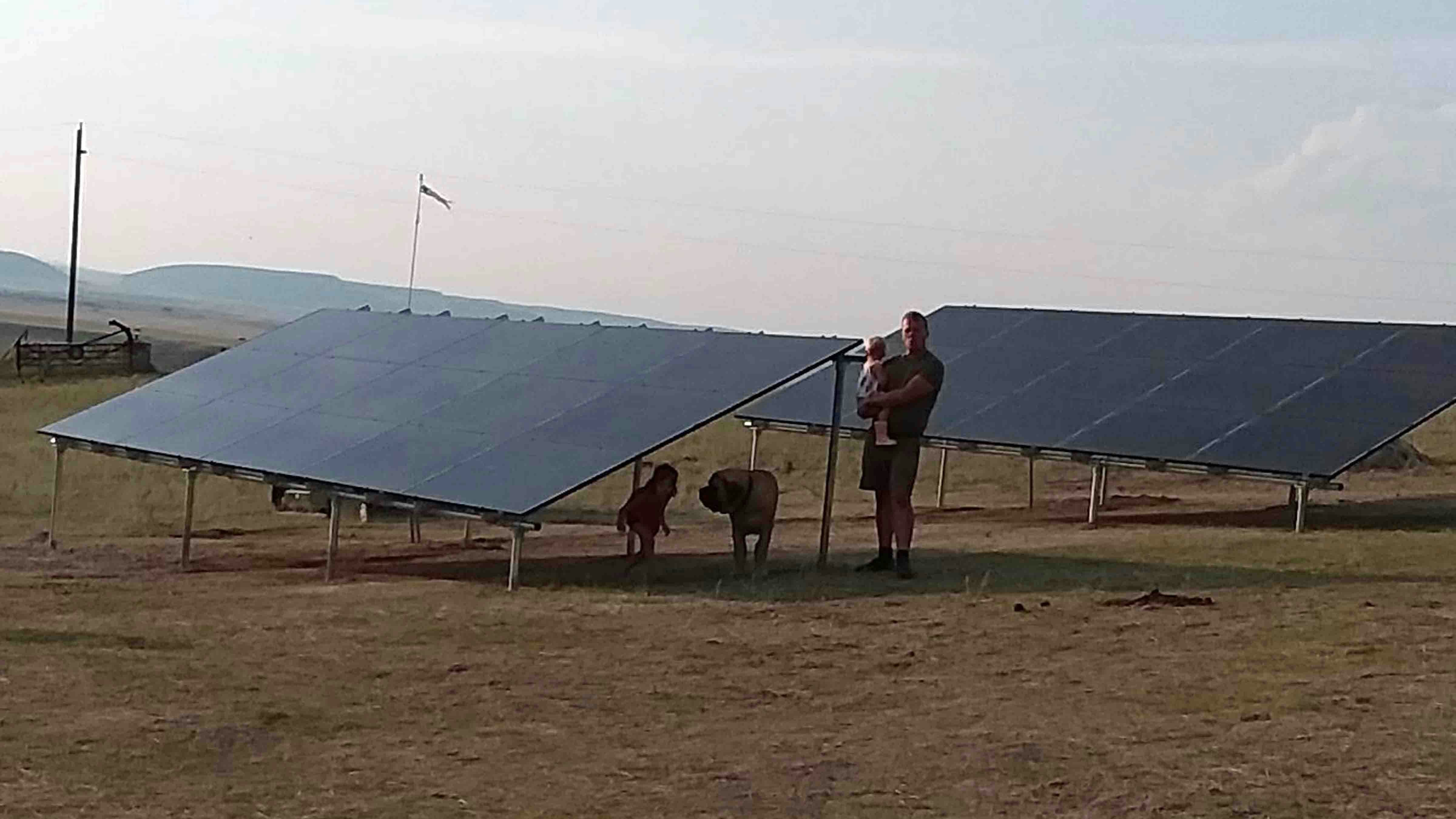 Christine Meadowcroft and her children posing with their new solar panels