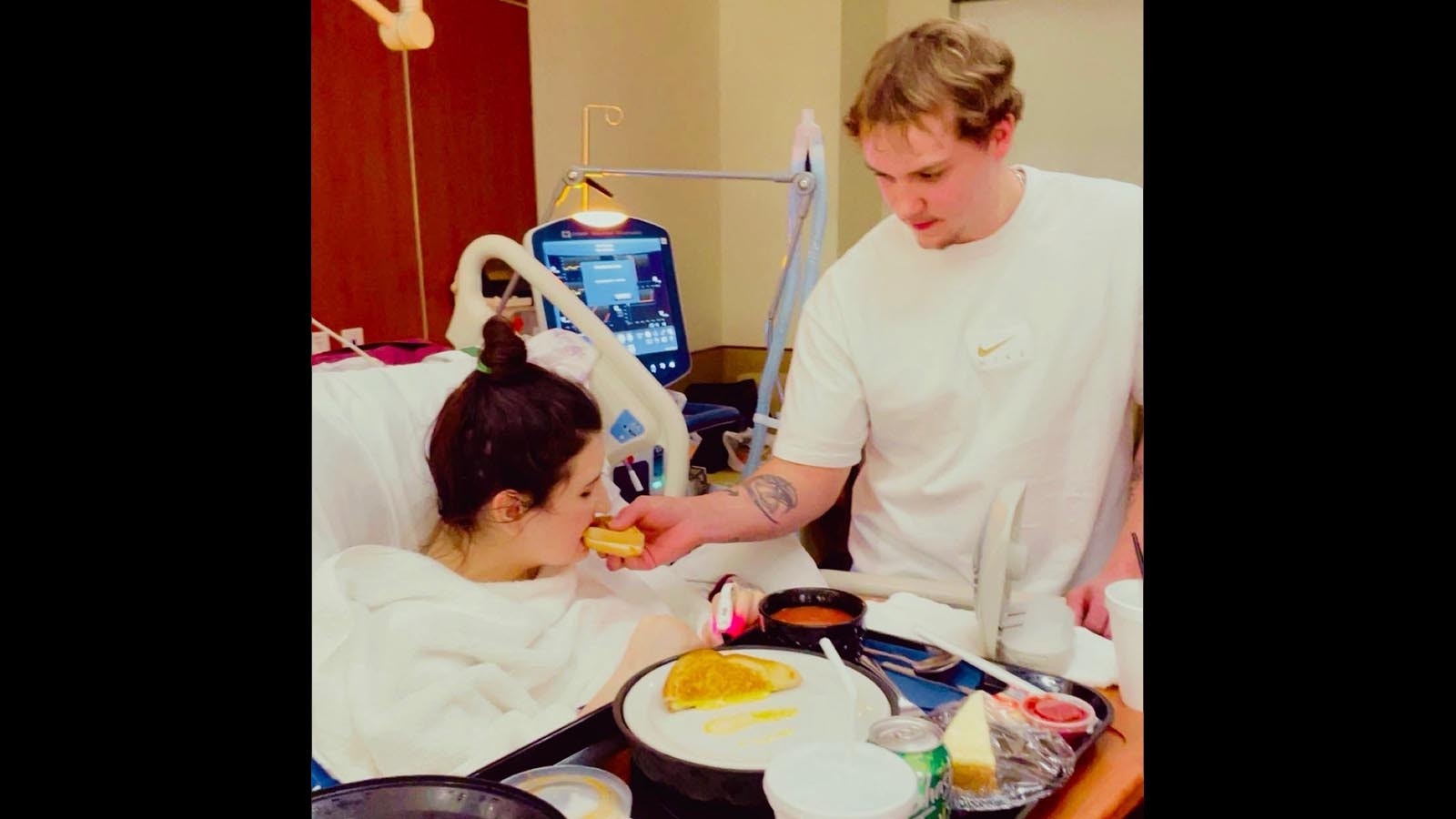 Kailey Kline is fed by her fiance, Shawn Snyder, in the hosptial.