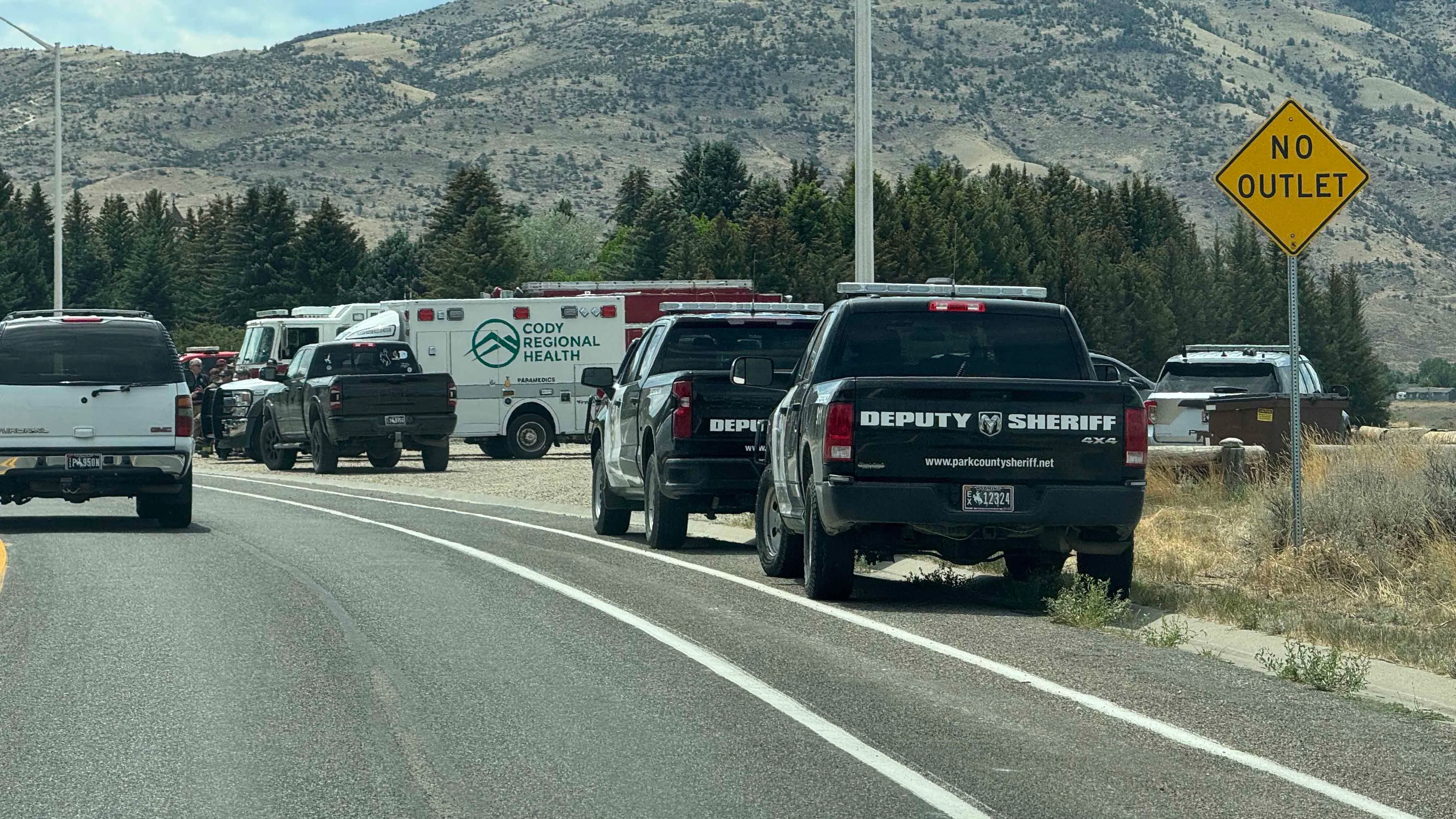 The Cody PD’s ballistic armored tactical transport vehicle, or “bearcat,” was on the scene as of 1:30 p.m. Wednesday, June 24, 2026. Officers in tactical gear and carrying firearms surrounded the residence, and an EMS crew from Cody Regional Health was on standby.