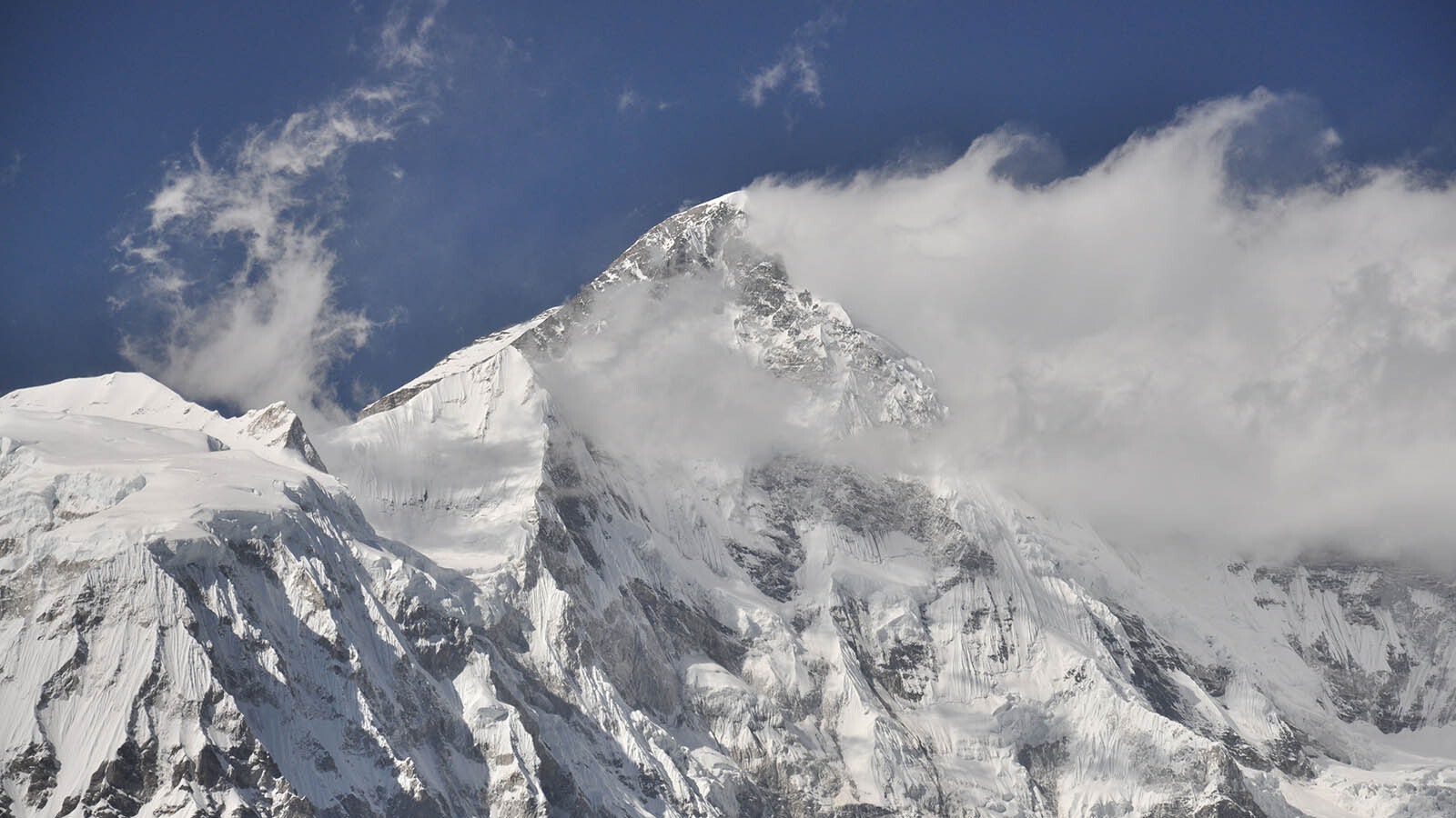 Strong wind gusts blow clouds of snow of this mountain peak in a file photo.