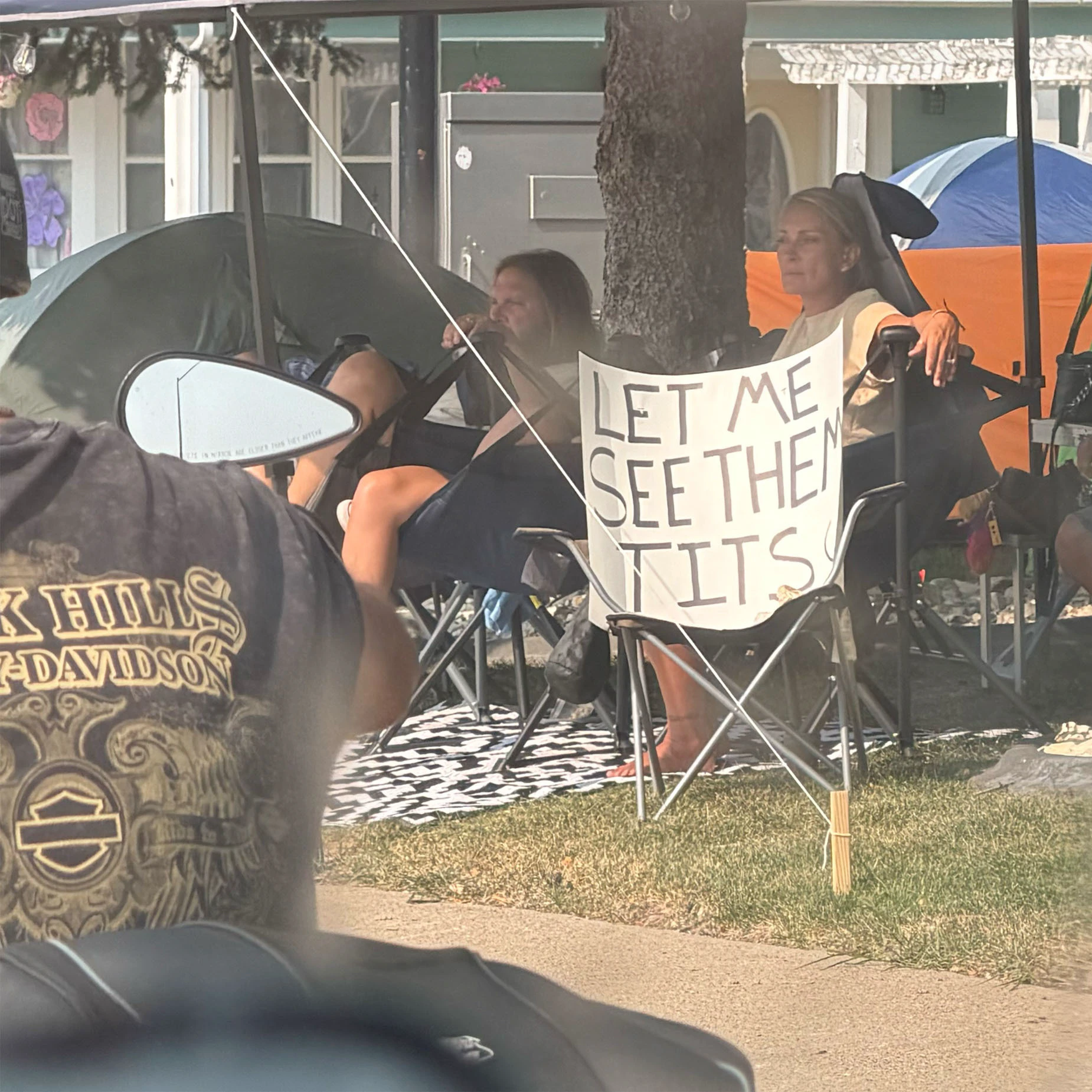 Sturgis rallygoers settle along the roadside with a simple request.