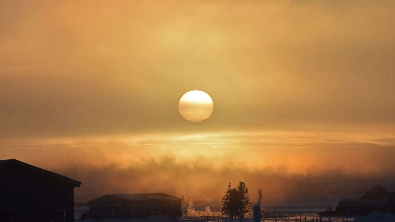 "This is the sunrise from this morning. Taken near Daniel, WY. Freezing fog created a surreal view of the sun."