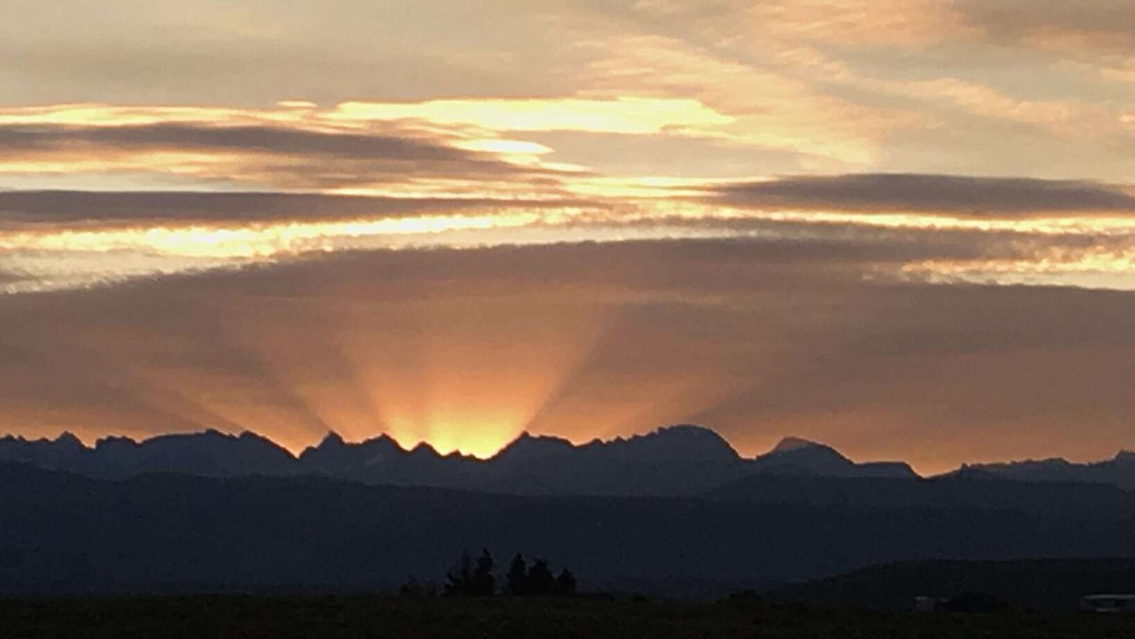 "Sunrise from Warren Bridge of Wind River Mountains." Thayne, WY