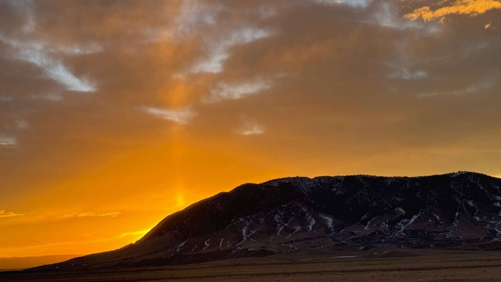 "Sunrise over Sheep Mountain near Centennial."