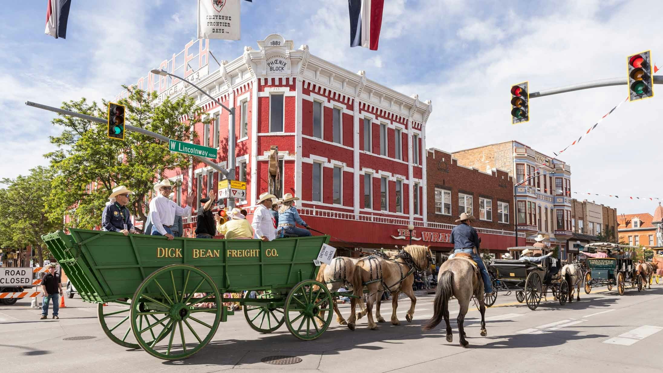 Horse-drawn wagons move through downtown during the Cheyenne Frontier Days Parade