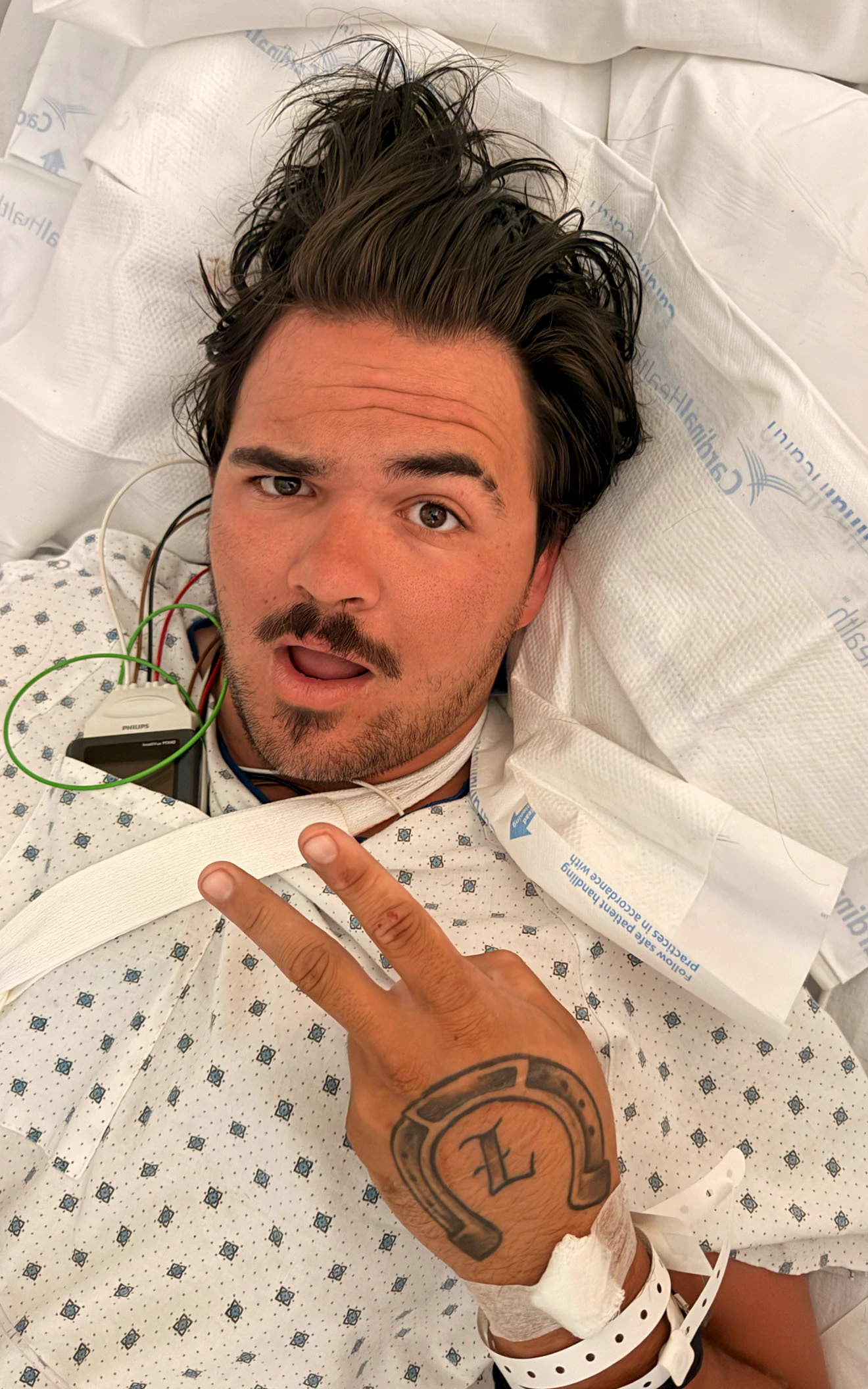Tanner Holcomb flashes a peace sign from his hospital bed after being injured in a motorcycle crash Wednesday in Casper. Holcomb spoke with Cowboy State Daily from the hospital about the collision and his years riding motorcycles.