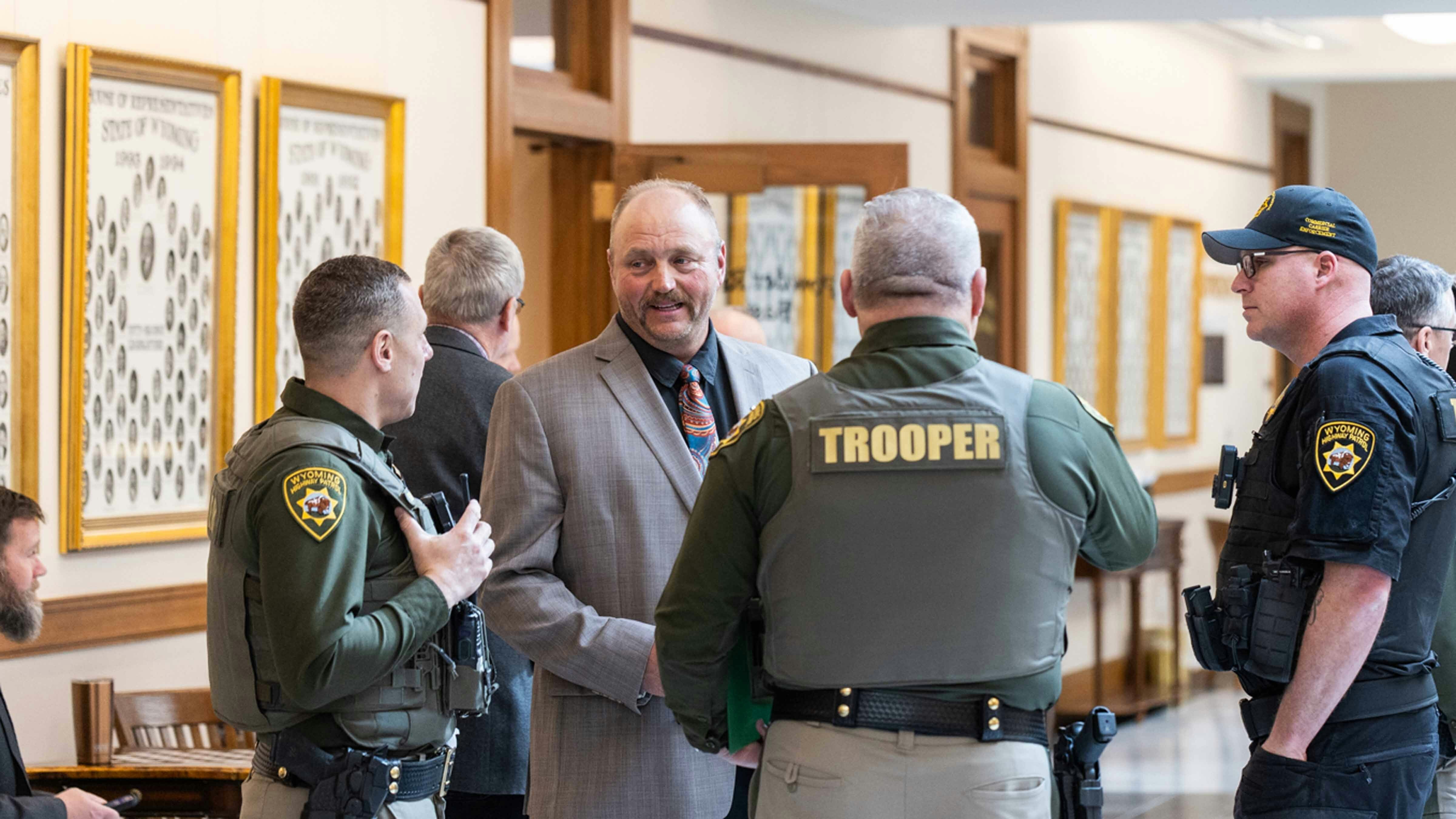 Representative Reuben Tarver talks with the Wyoming Highway Patrol Department after the House Transportation Committee Meeting on Bill HB0032 - English Proficiency-Commercial Motor Vehicle Drivers
