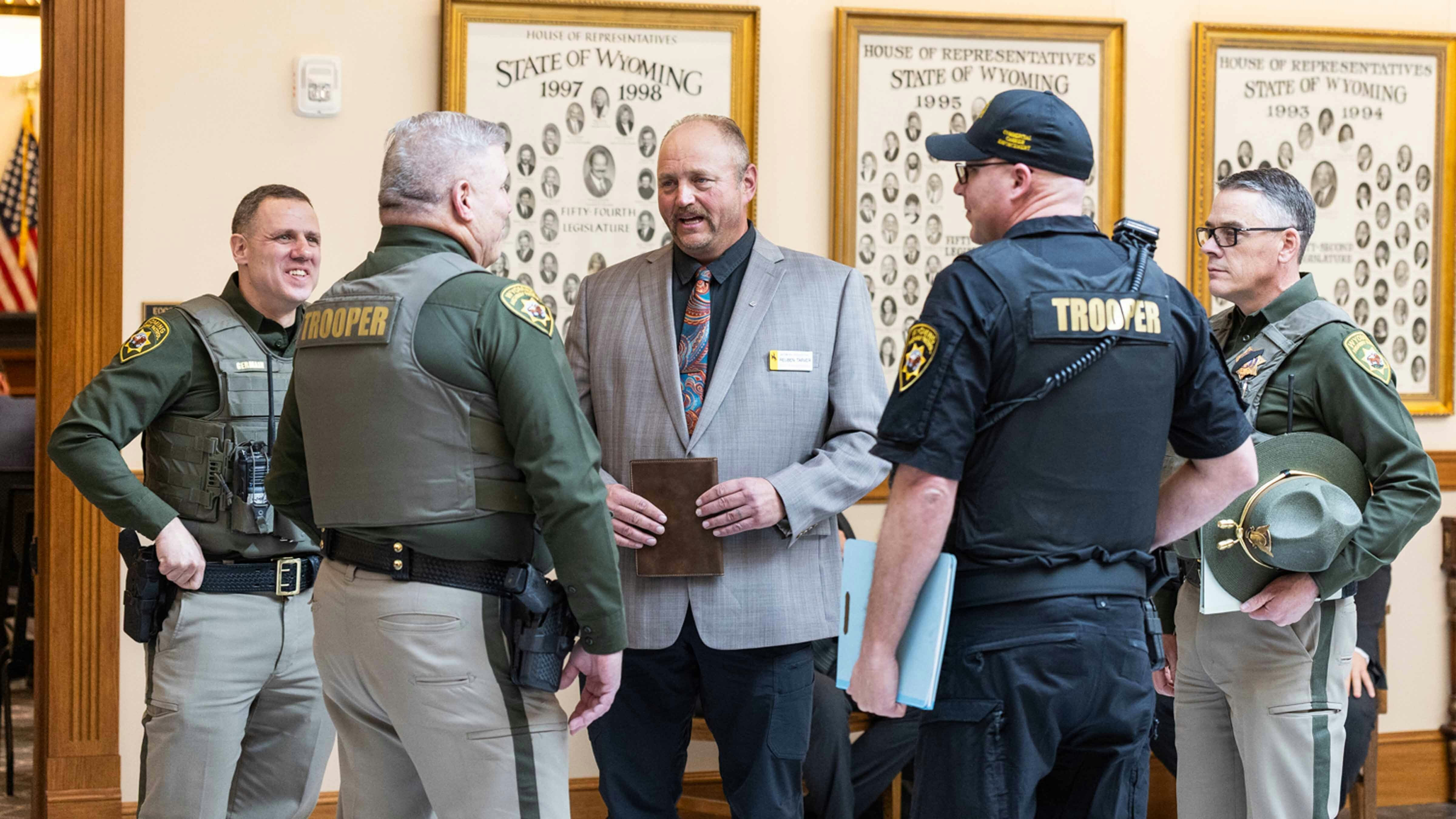 Representative Reuben Tarver talks with the Wyoming Highway Patrol Department after the House Transportation Committee Meeting on Bill HB0032 - English Proficiency-Commercial Motor Vehicle Drivers