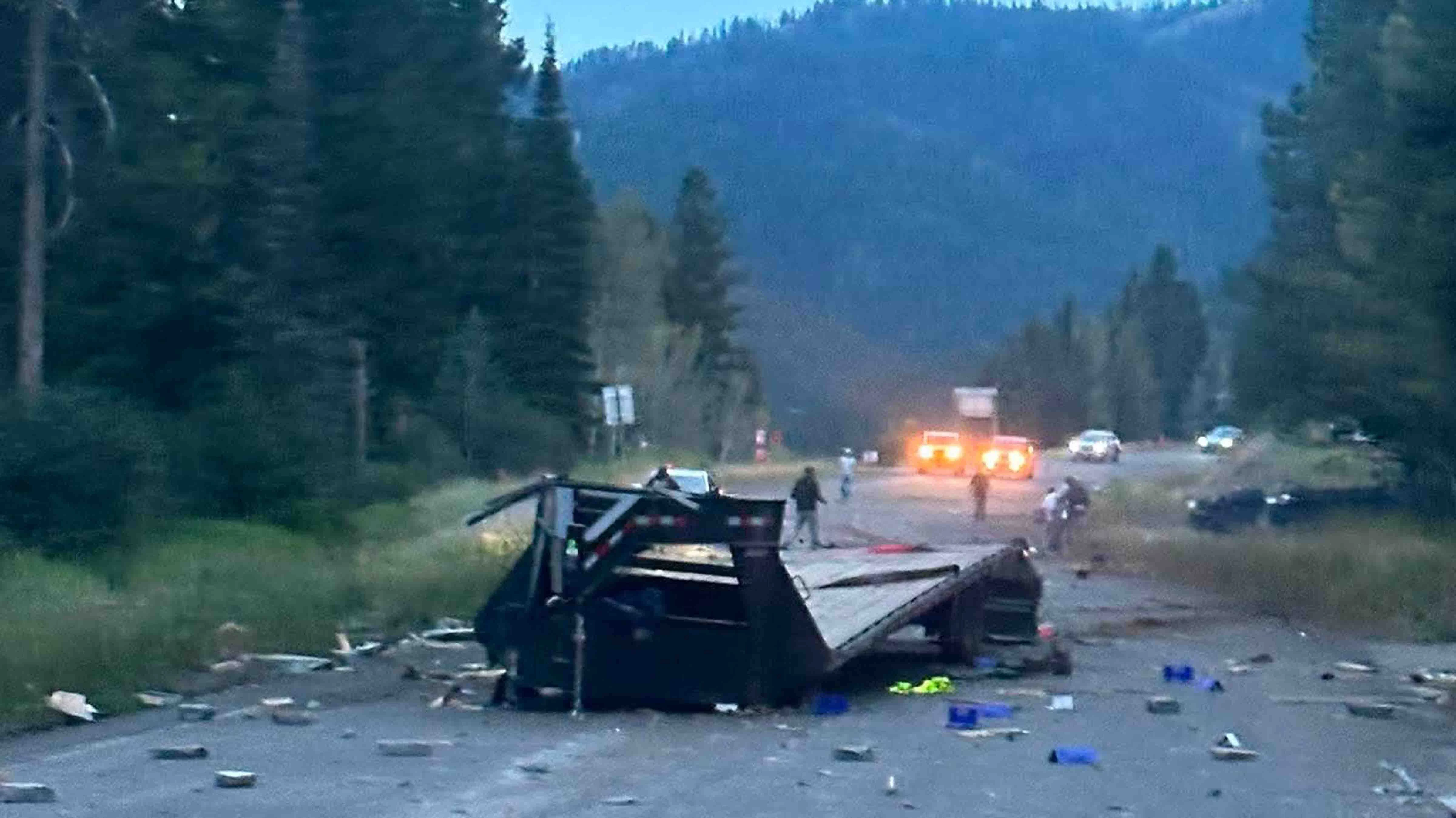 Debris and the wrecked utility trailer cover Wyoming Highway 22 after a fatal crash Wednesday evening on Teton Pass