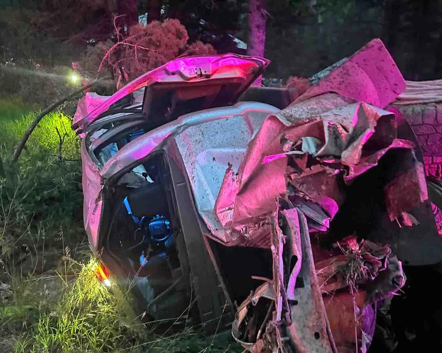 A mangled Ford F-250 rests off Wyoming Highway 22 after a fatal rollover on Teton Pass on Wednesday evening