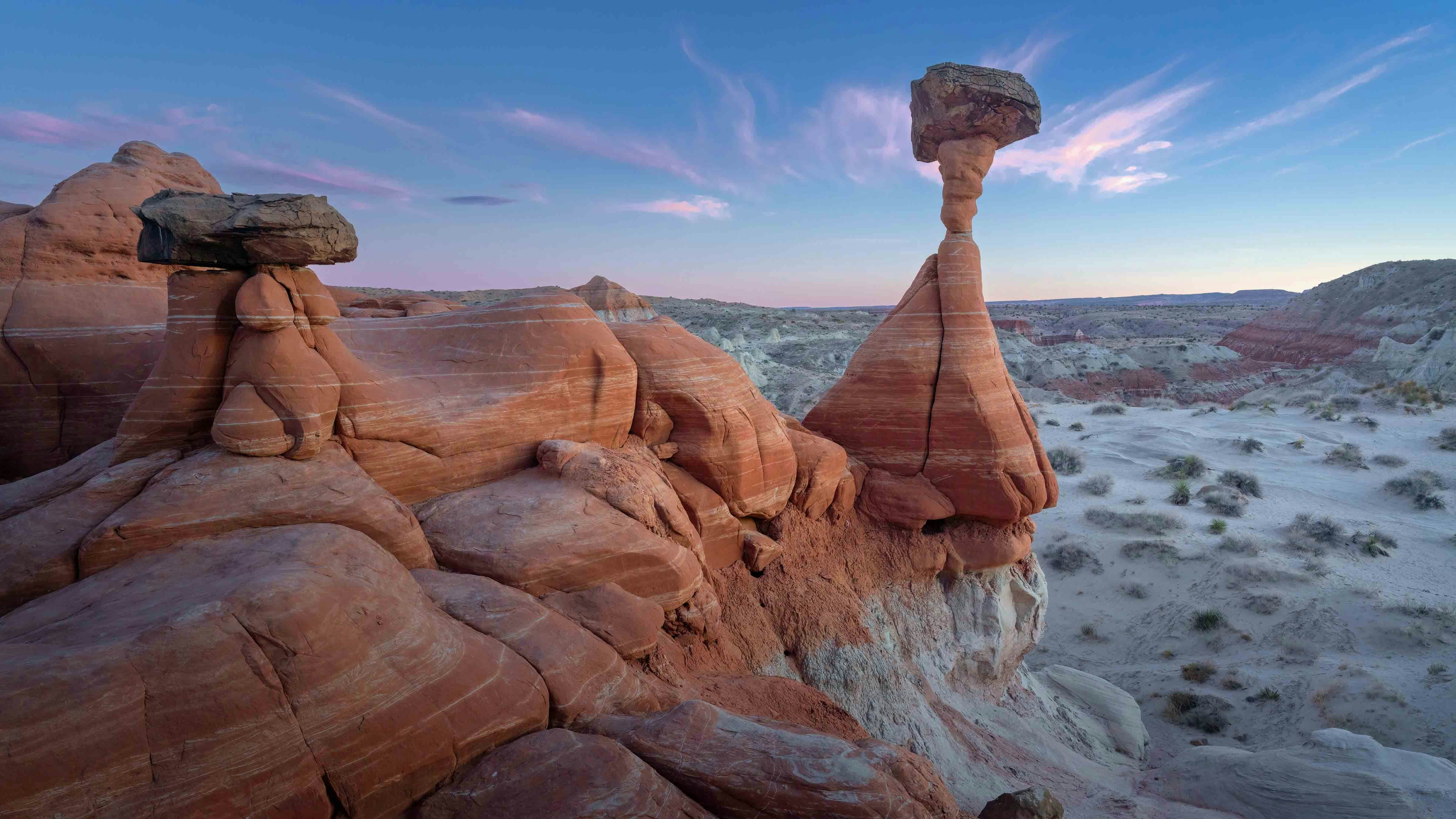 Scenic view of red rock Toadstool Hoodoos against sky in evening, Kanab, Utah.