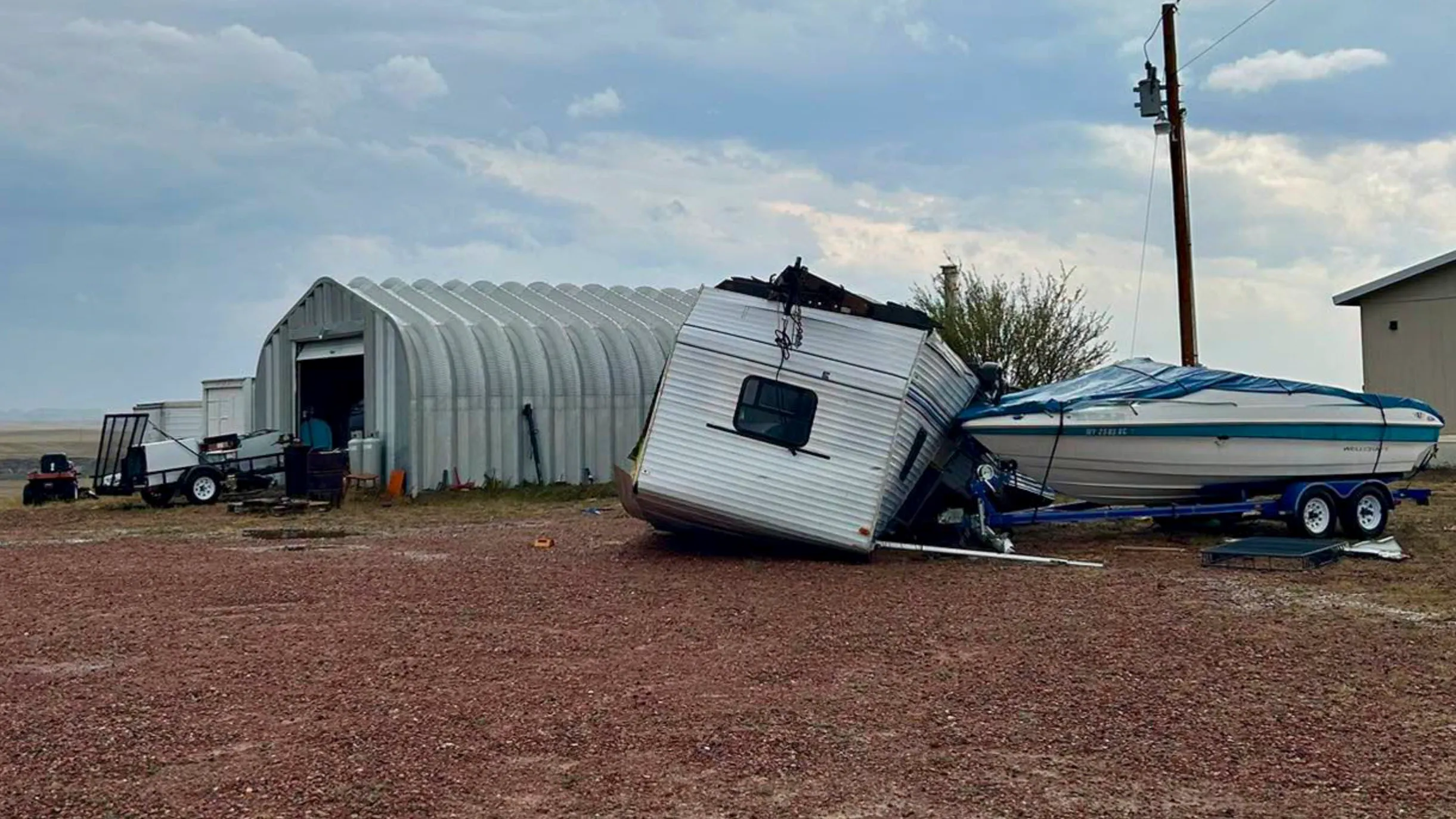 Debris is scattered across properties near South Highway 59 and Rattlesnake Road in Campbell County after a possible tornado Wednesday afternoon ripped roofs from buildings, damaged homes and overturned a camper