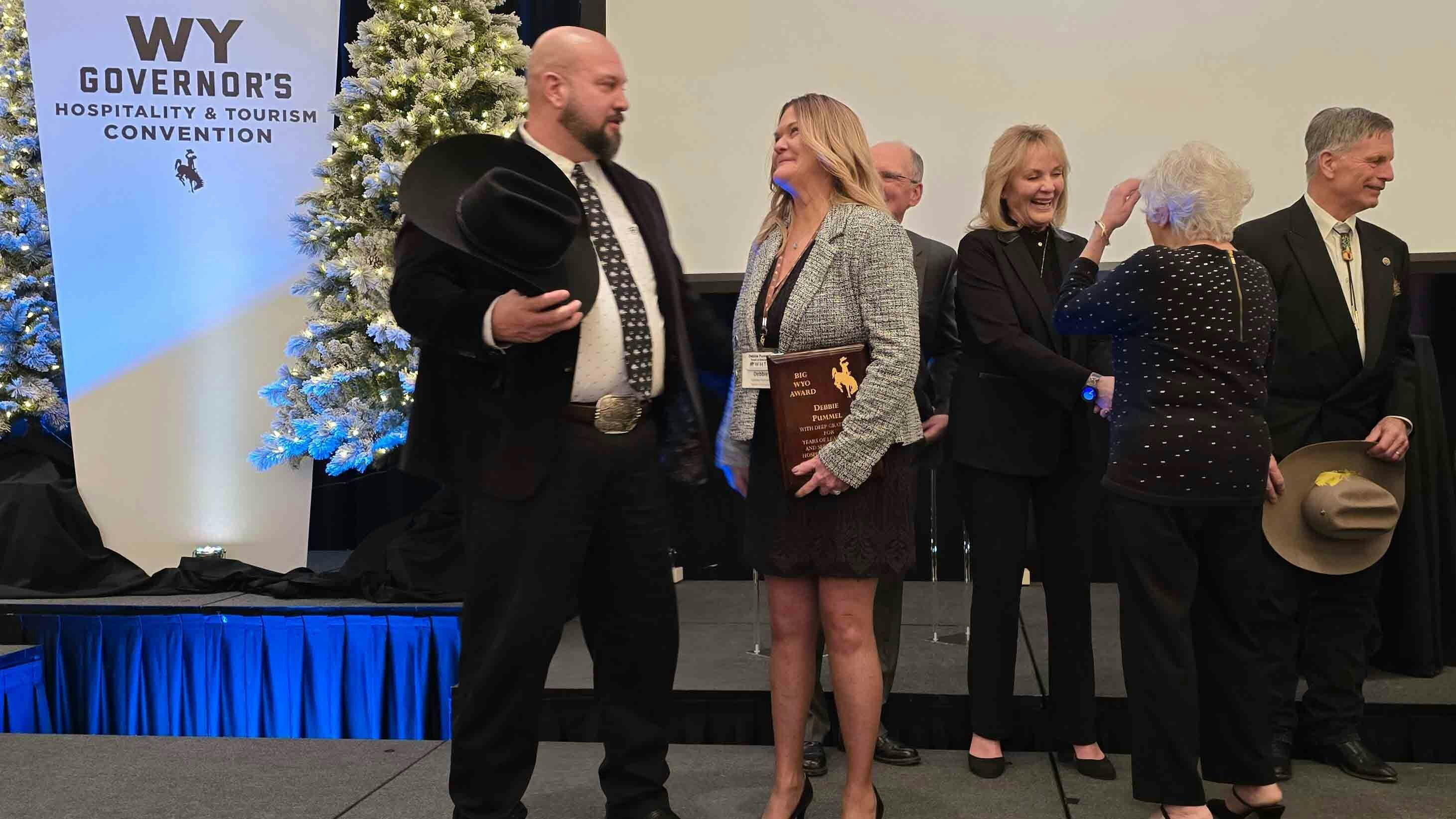 Debbie Pummel, right, talks with Wyoming Office of Tourism Executive Director Domenic Bravo after she was named winner of the BigWYO 2026 award during the Wyoming Governor's Hospitality & Tourism Convention.