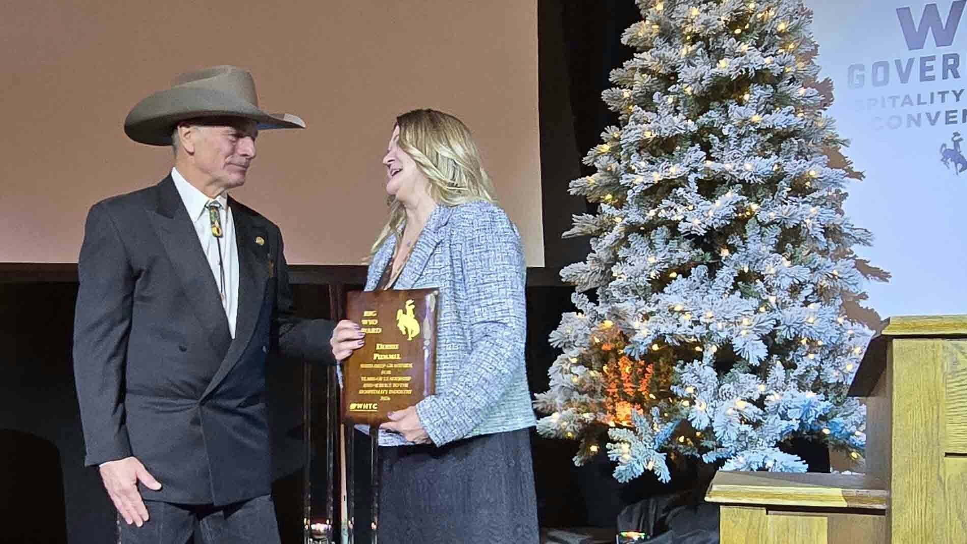Debbie Pommel speaks with Gov. Mark Gordon after winning the BigWYO award.