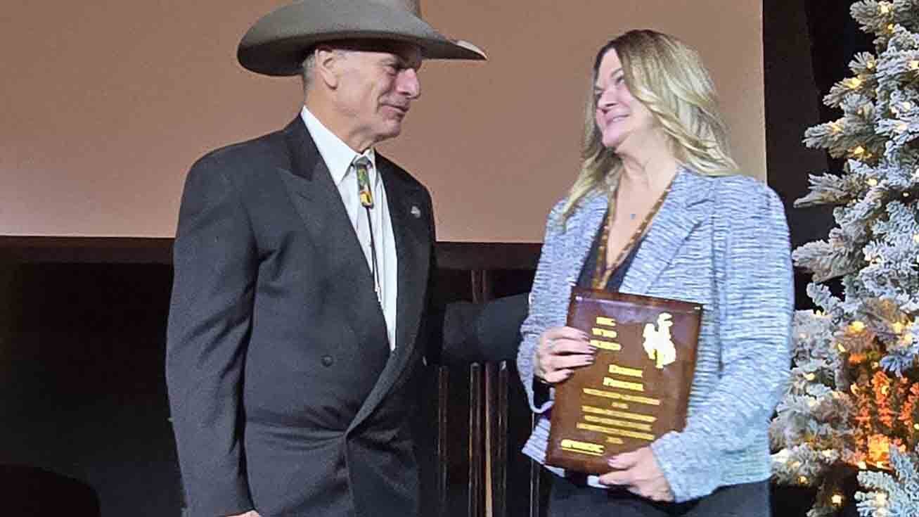 Debbie Pommel speaks with Gov. Mark Gordon after winning the BigWYO award.