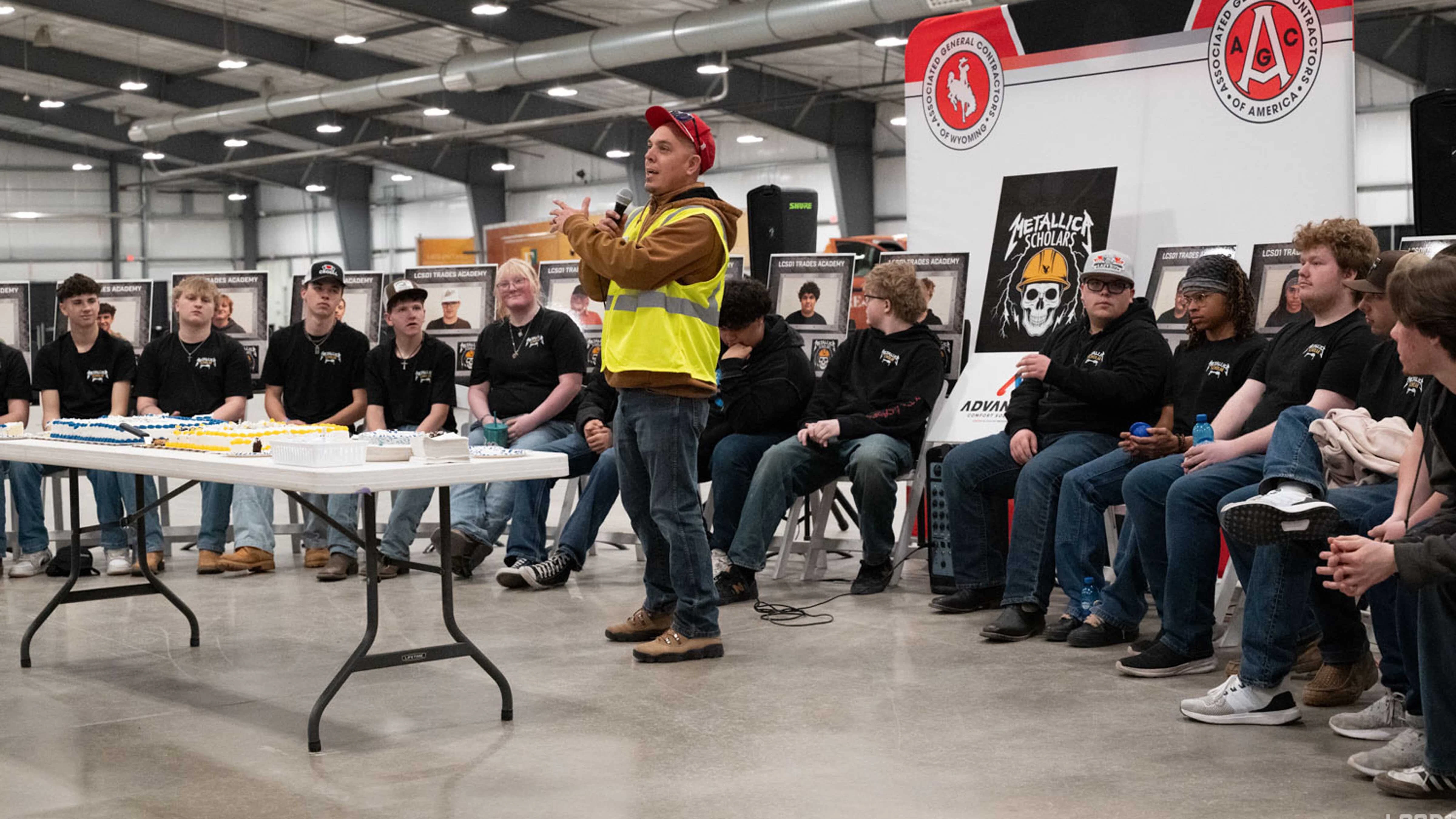 Associated General Contractors of Wyoming CEO Dan Benford talks to parents and community members at the Metallica Scholars Ribbon Cutting