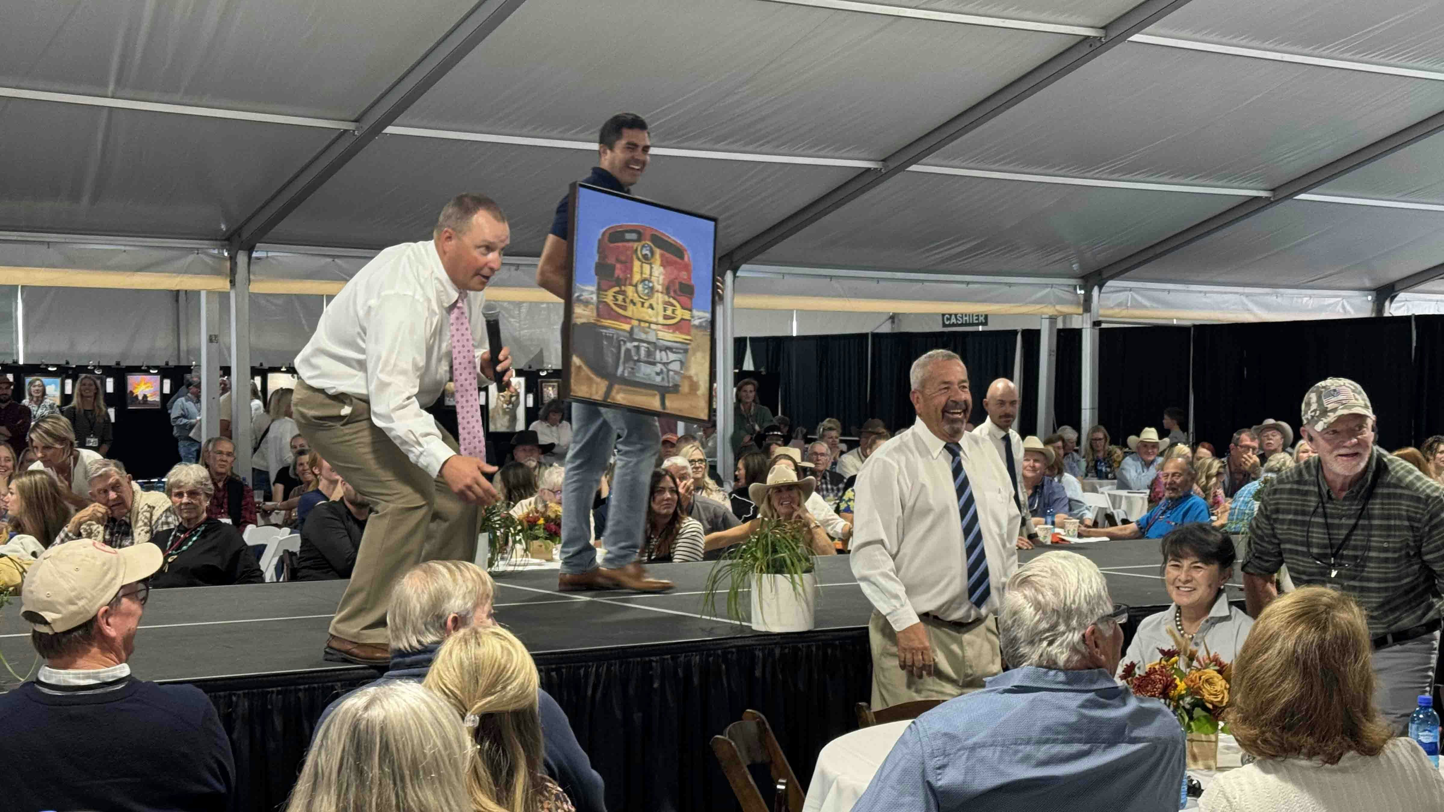 Auctioneer Troy Black drums up bids for a painting by Santiago Michaelek during the 44th Buffalo Bill Art Show and Sale's Saturday morning Quick Draw auction. It sold for $17,000.
