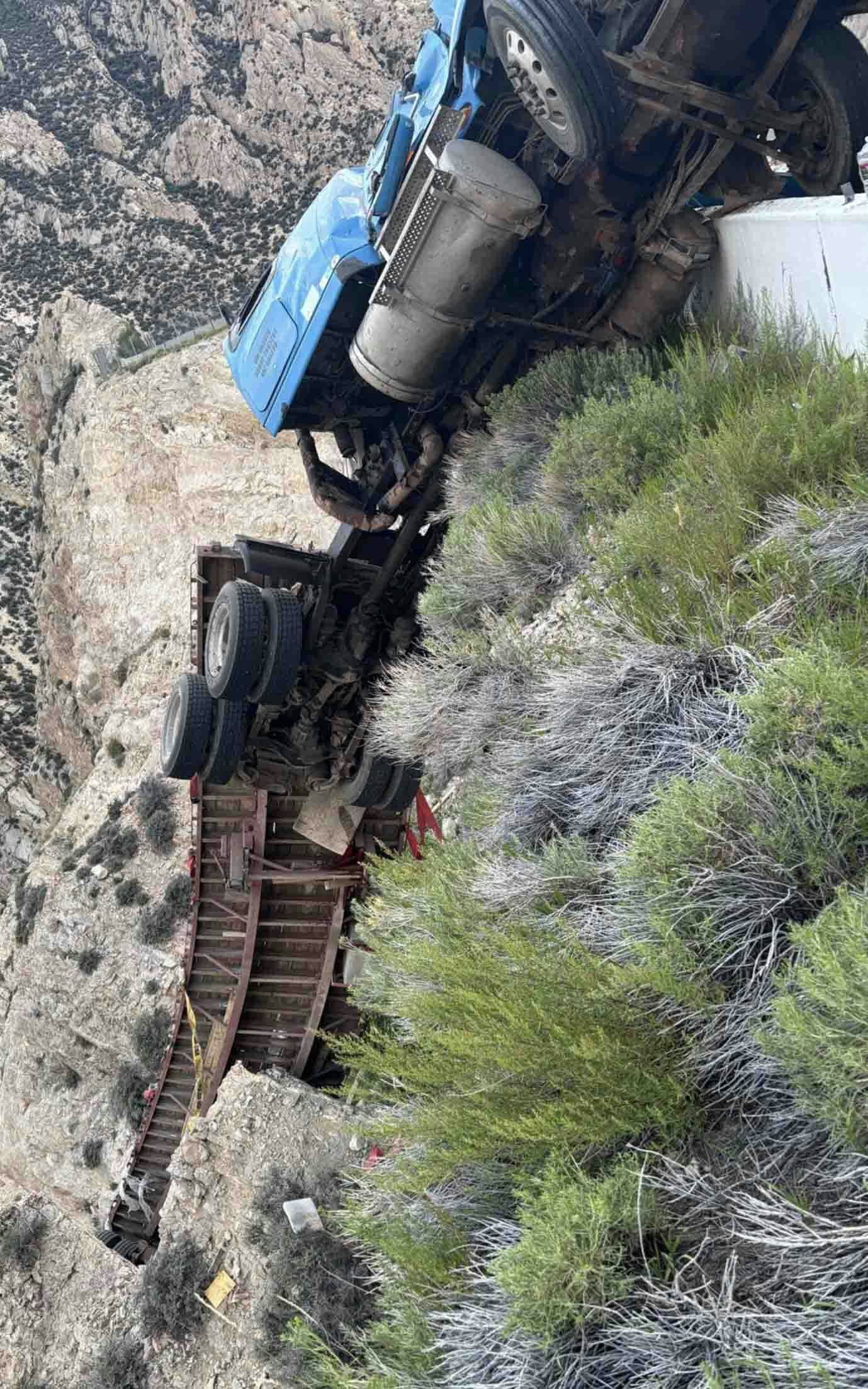 A semi driver is alive and well after his truck careened off U.S. Highway 14-A in northern Wyoming. Somehow the semi managed to hang on and remains dangling perilously over a cliff.