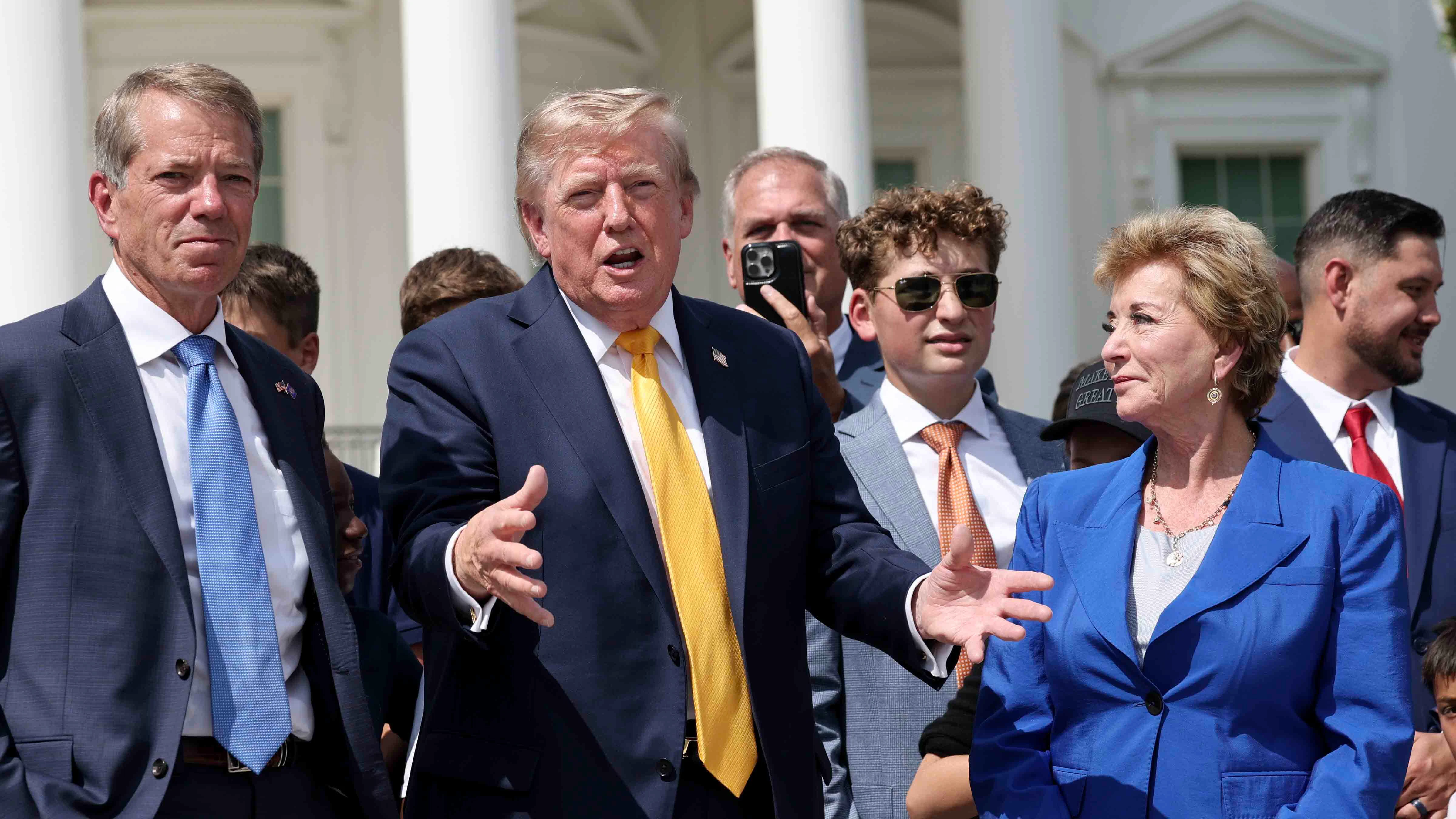 U.S. President Donald Trump and Secretary of Education Linda McMahon show off the White House helipad construction on the South Lawn of the White House after an event in the Rose Garden of the White House on August 24, 2026 in Washington, DC. The multimillion-dollar granite helipad is designed to accommodate Marine One helicopters and is slated for completion in 2026.