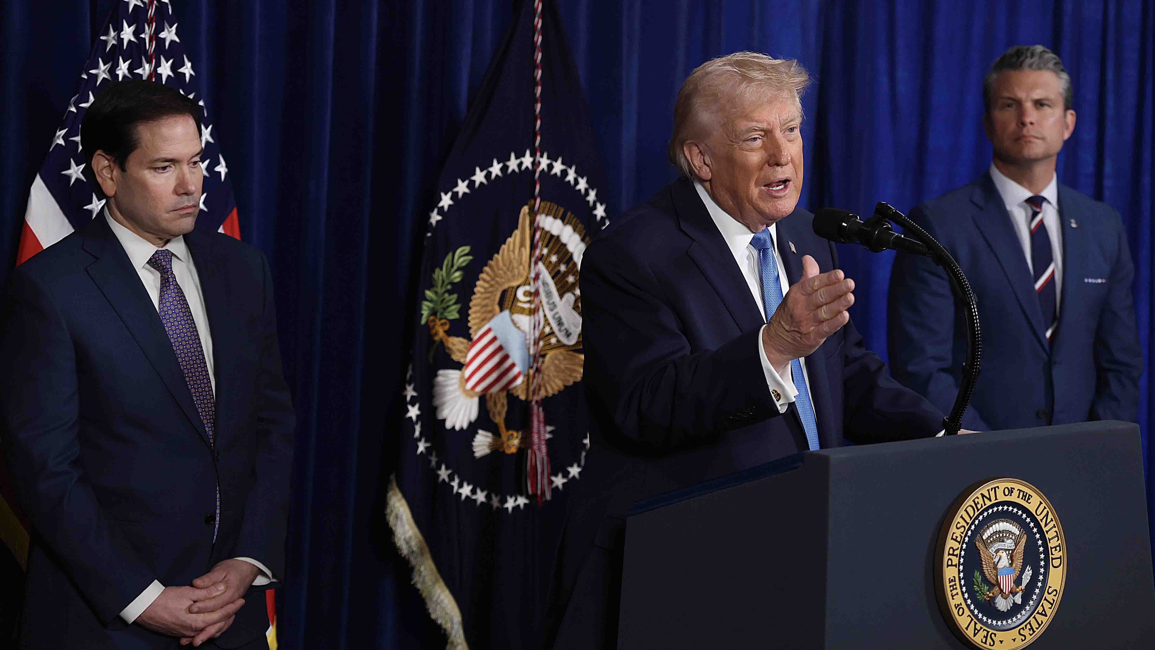 Secretary of State Marco Rubio and Secretary of War Pete Hegseth listen as U.S. President Donald Trump addresses the media during a news conference at his Mar-a-Lago club on January 03, 2026, in Palm Beach, Florida.