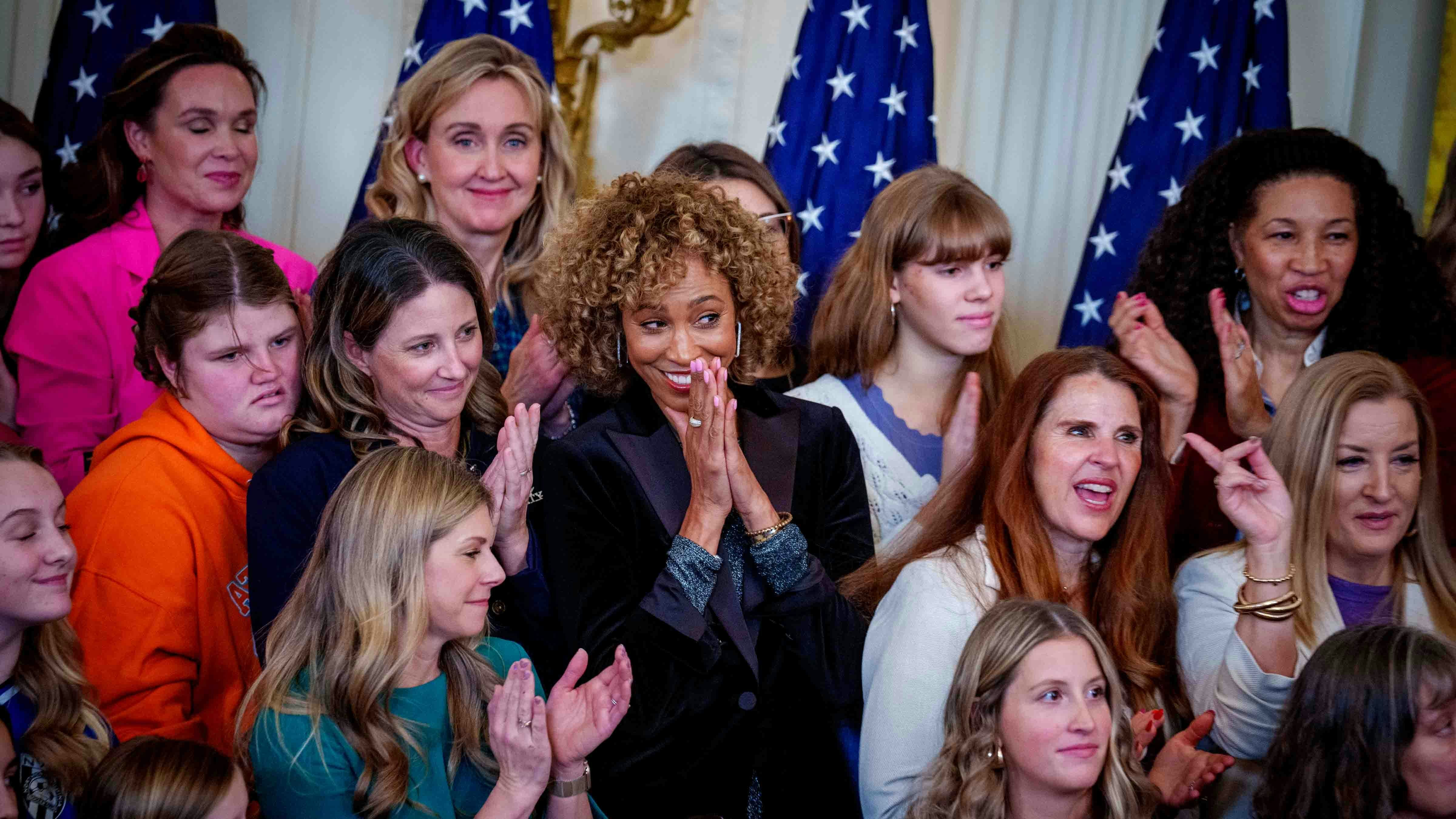 Sage Steele reacts while standing behind U.S. President Donald Trump as he recognizes her before he signs the "No Men in Women's Sports" executive order in the East Room of the White House on February 5, 2025 in Washington, DC.