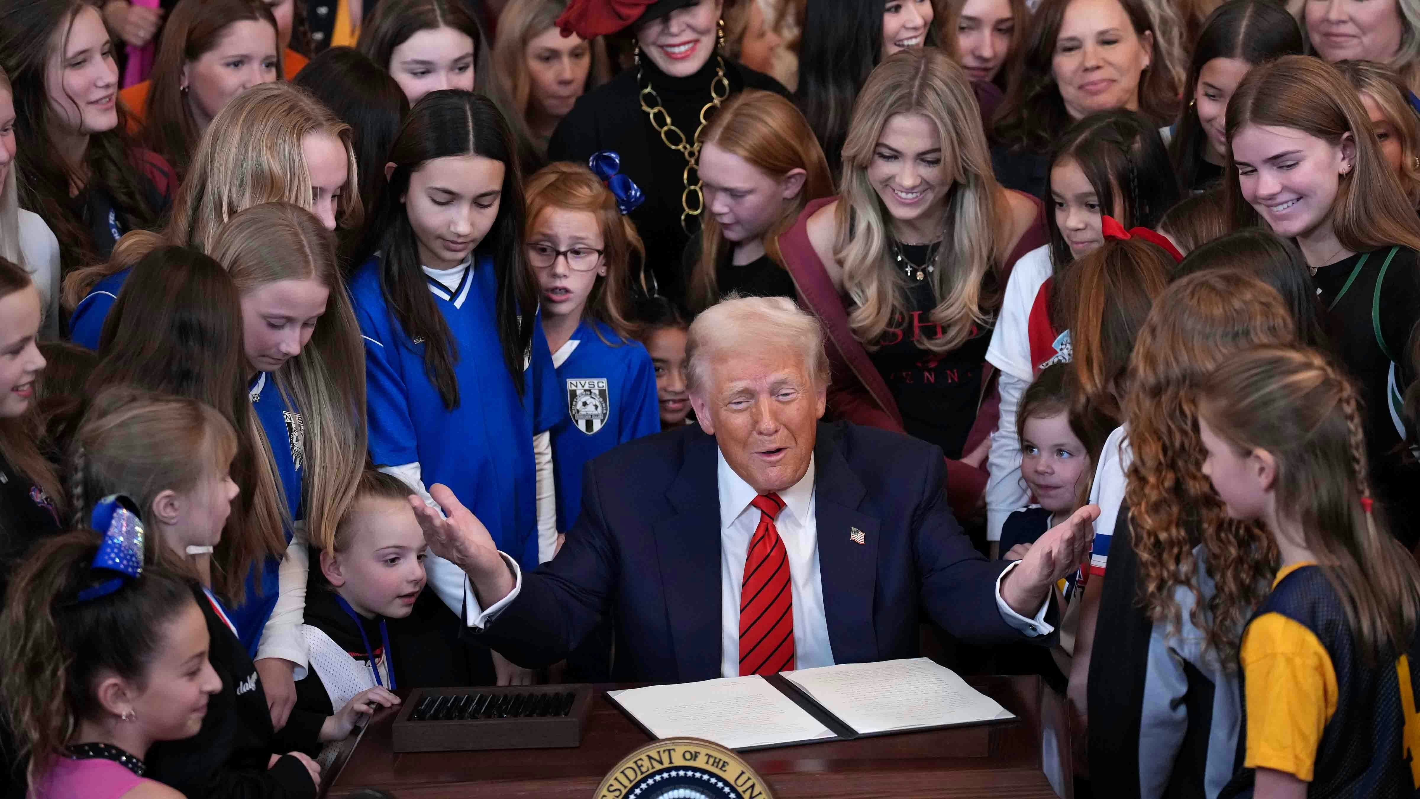 U.S. President Donald Trump joined by women athletes signs the “No Men in Women’s Sports” executive order in the East Room at the White House on February 5, 2025 in Washington, DC.