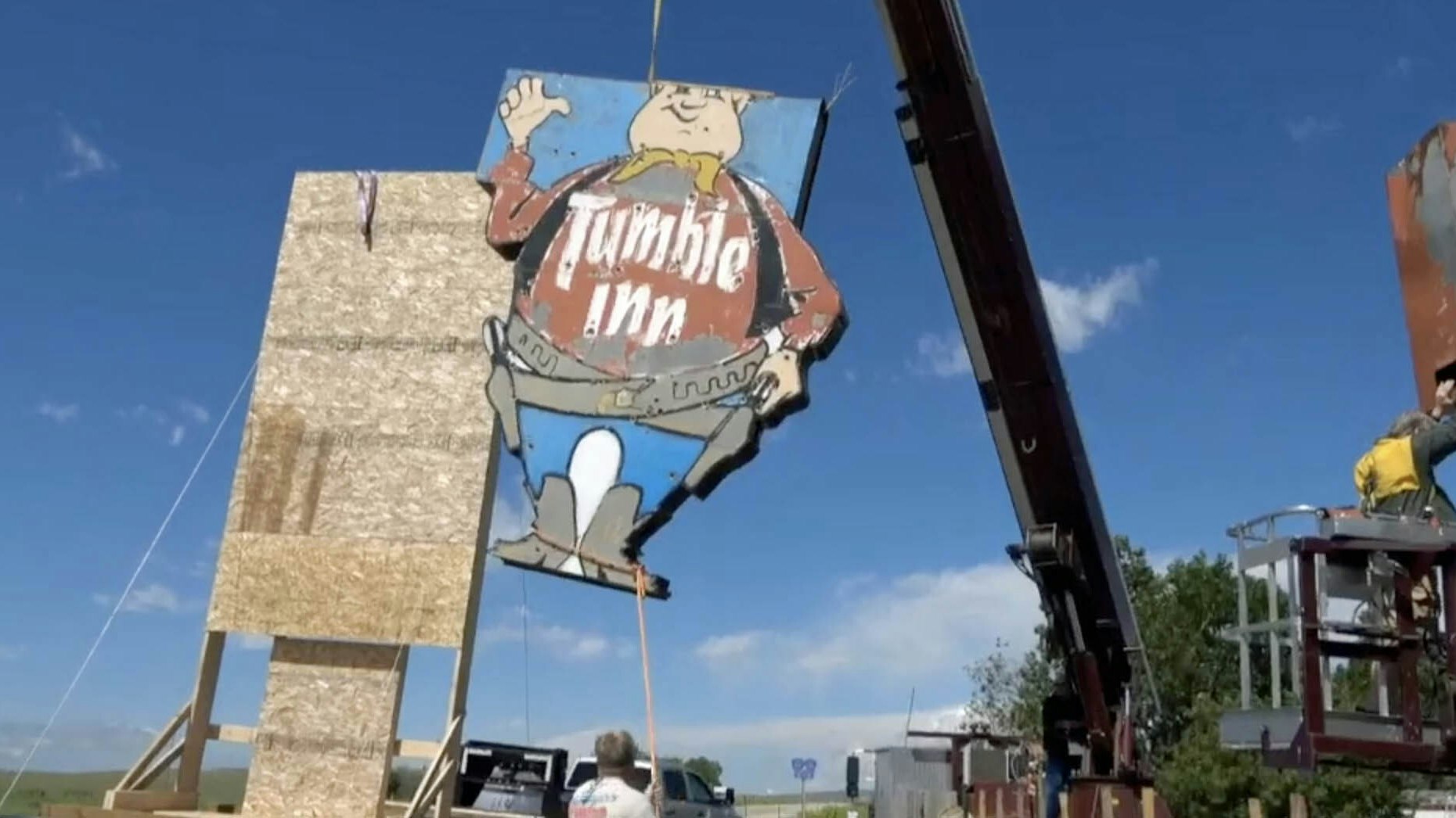 The Tumble Inn Cowboy is carefully taken down.