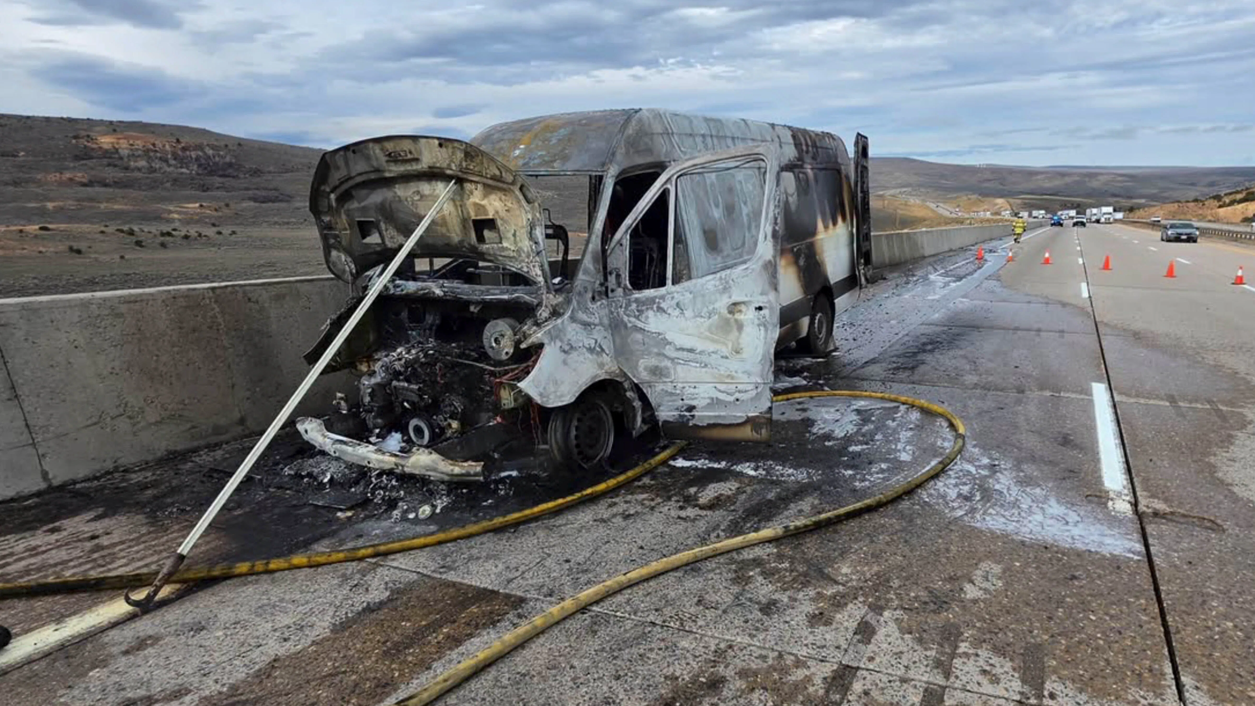 A Mercedes cargo van sits charred along eastbound Interstate 80 near milepost 20 east of Evanston on Thursday after catching fire