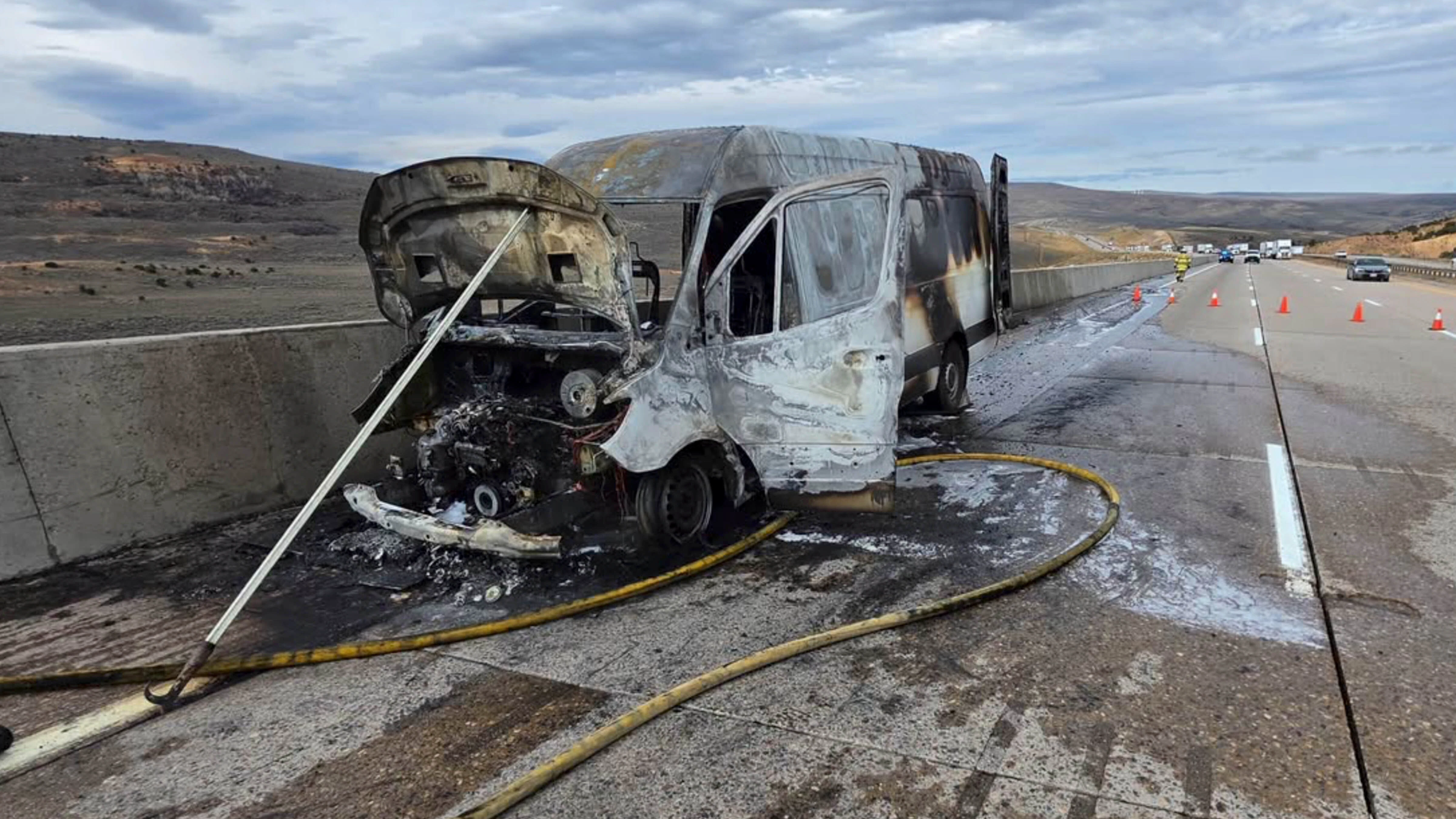 A Mercedes cargo van sits charred along eastbound Interstate 80 near milepost 20 east of Evanston on Thursday after catching fire