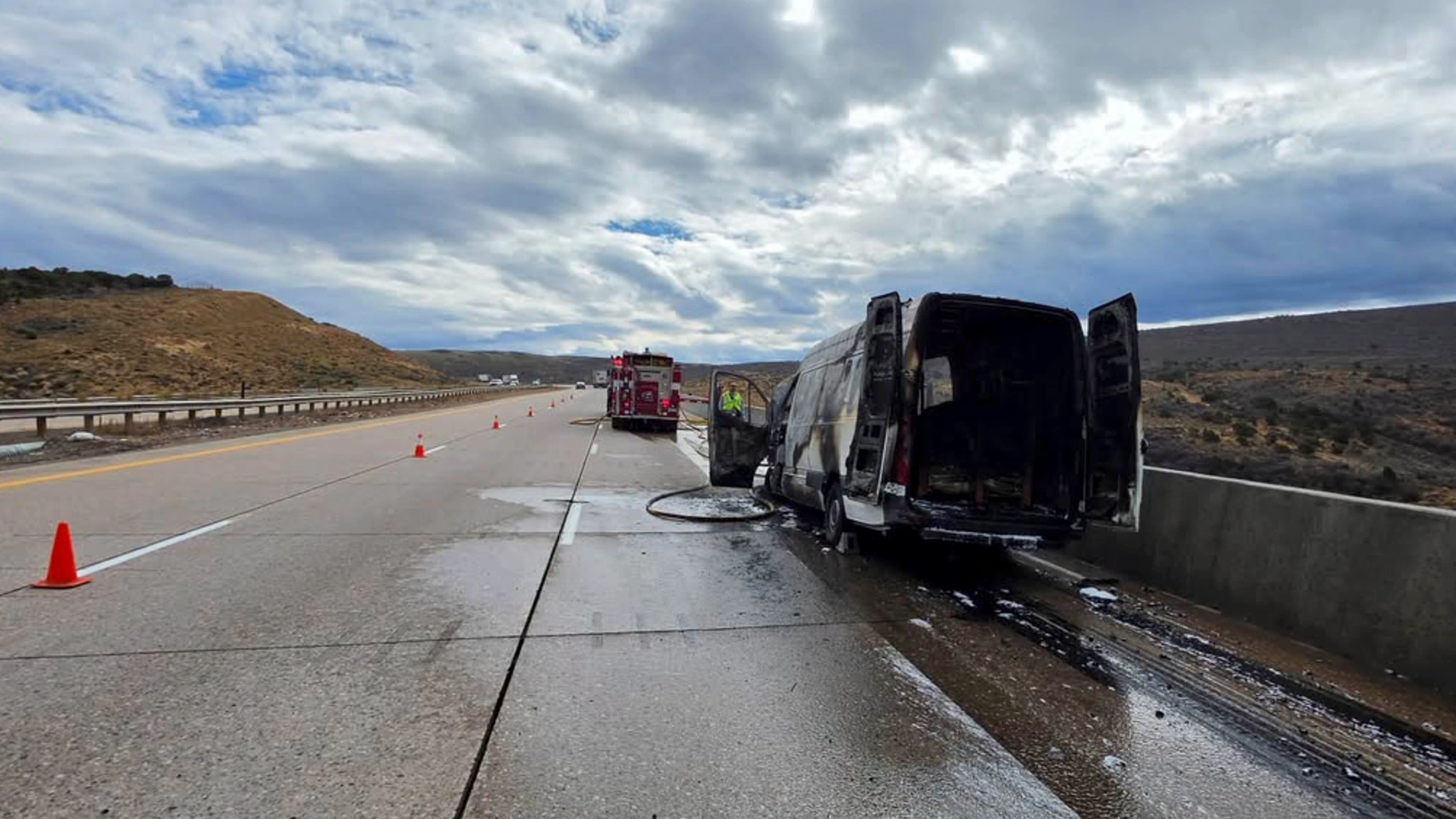 A Mercedes cargo van sits charred along eastbound Interstate 80 near milepost 20 east of Evanston on Thursday after catching fire