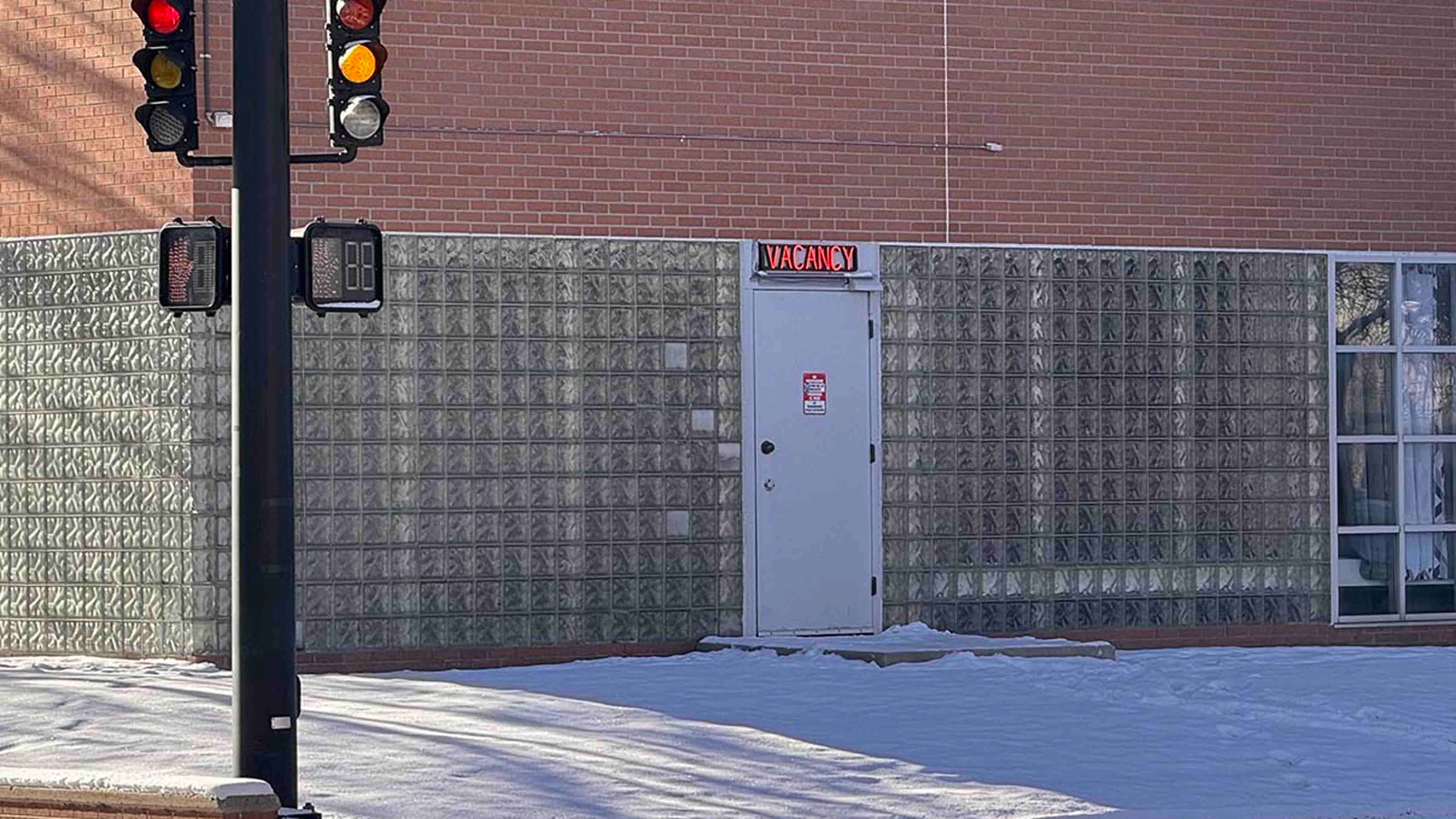 A motel-style "vacancy" sign flashes red over the north door of the Laramie County jail at the intersection of Pioneer Avenue and 20th Street in downtown Cheyenne.