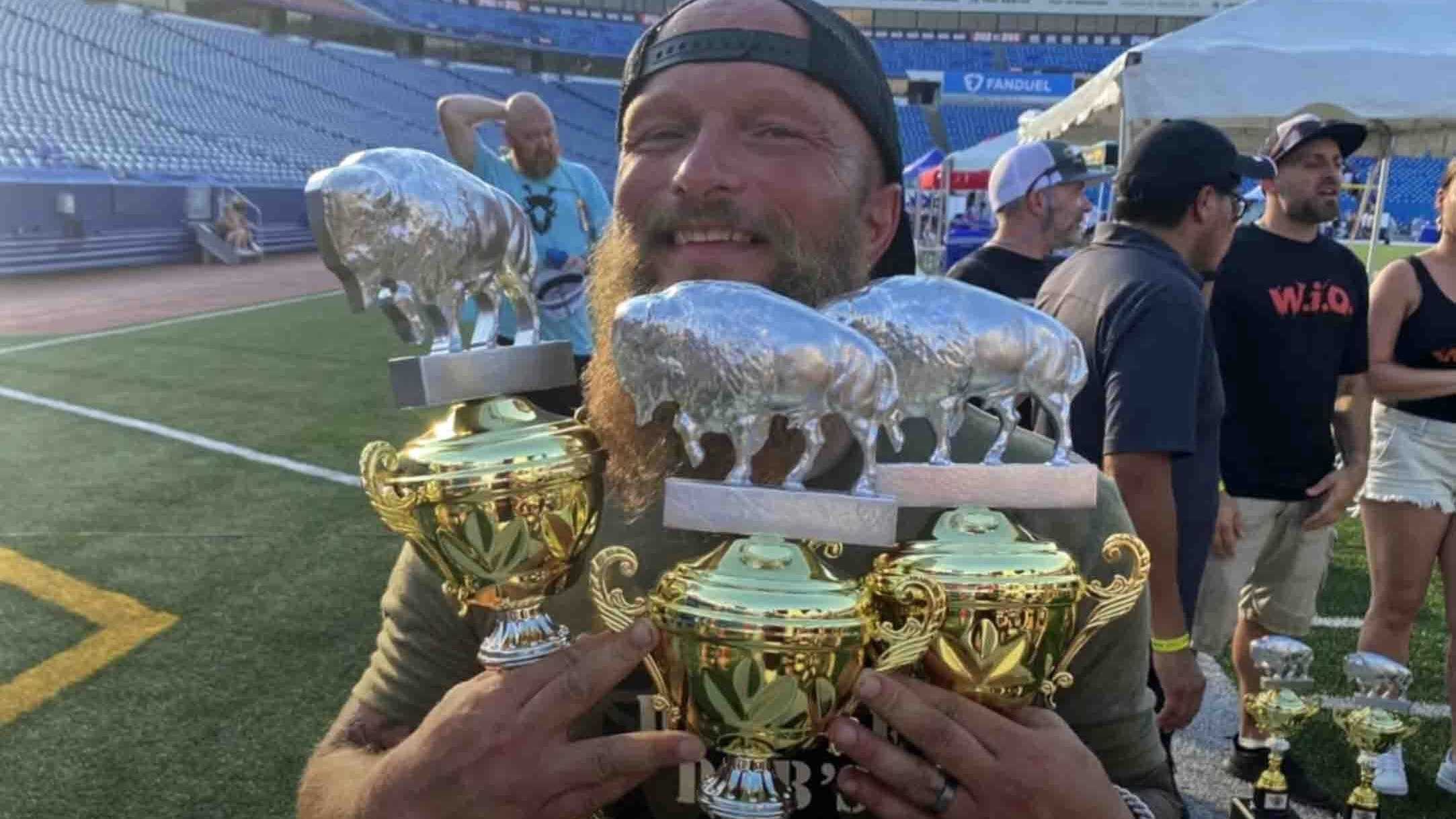 Trent Weitzel with a handful of trophies won at the 2022 National Buffalo Wing Festival in Buffalo, New York, including the coveted Festival Favorite.