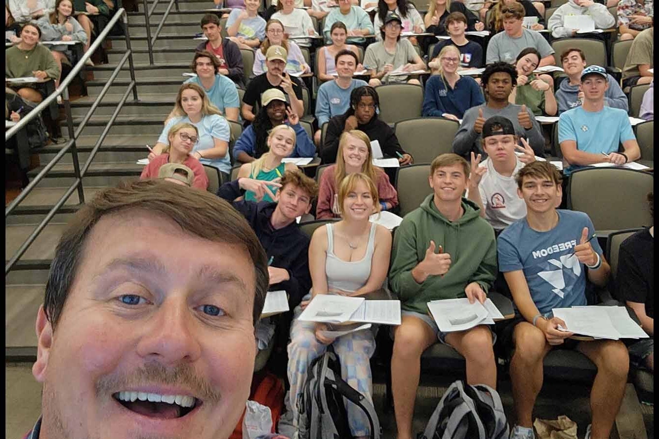 Dr. Matt Wielicki takes a selfie with students on his last day of teaching at the University of Alabama.