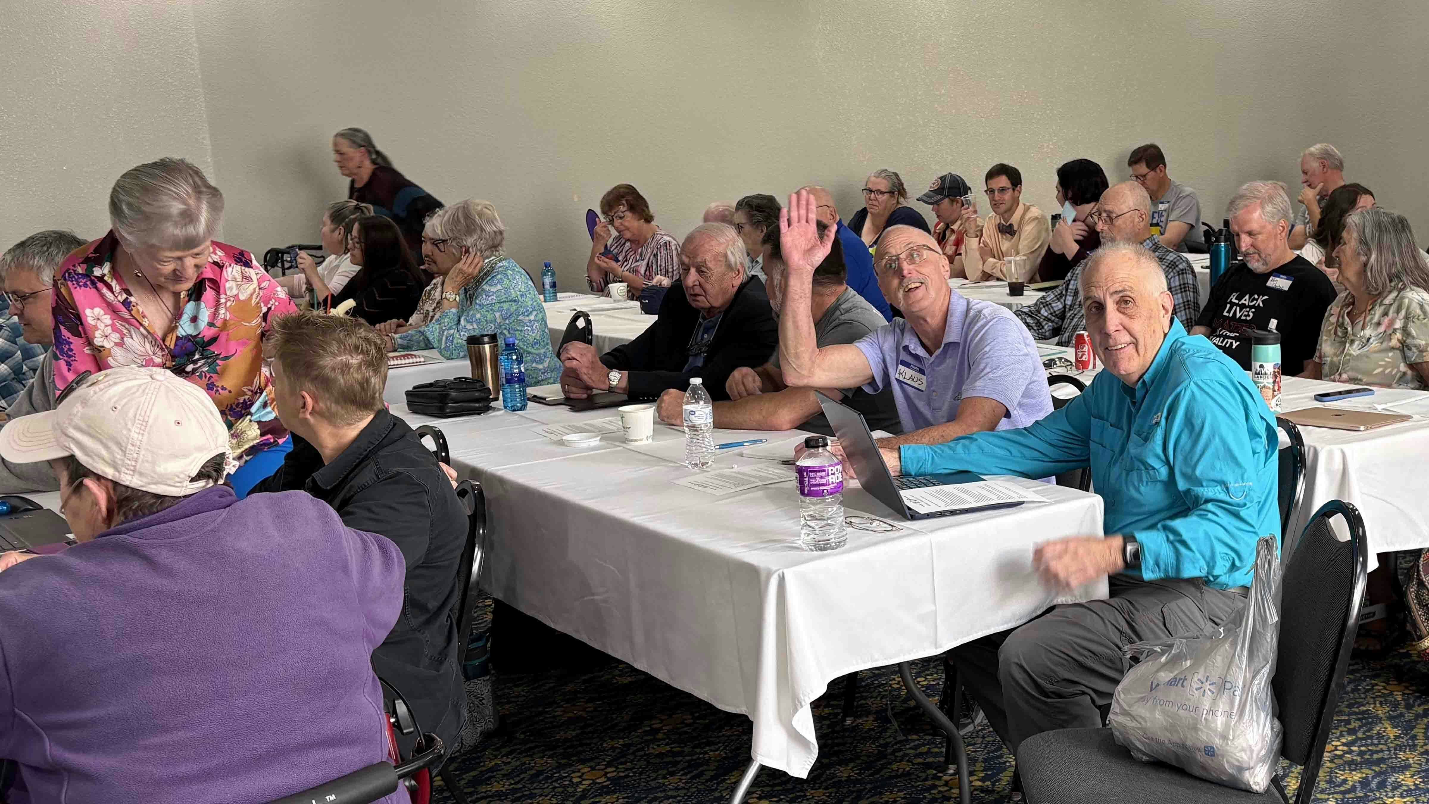 Albany County Democratic Party Chair Klaus Halbsgut waved while being photographed alongside other delegates to the Wyoming Democratic State Central Committee.
