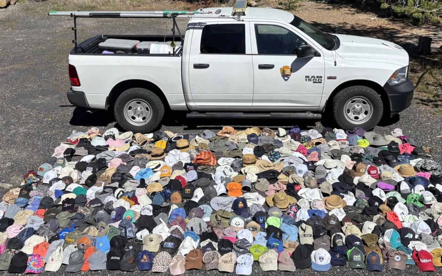 Hats collected by the Yellowstone National Park Geology Team and other park staff from hydrothermal areas during the summer 2026 season (Geology Team truck for scale).