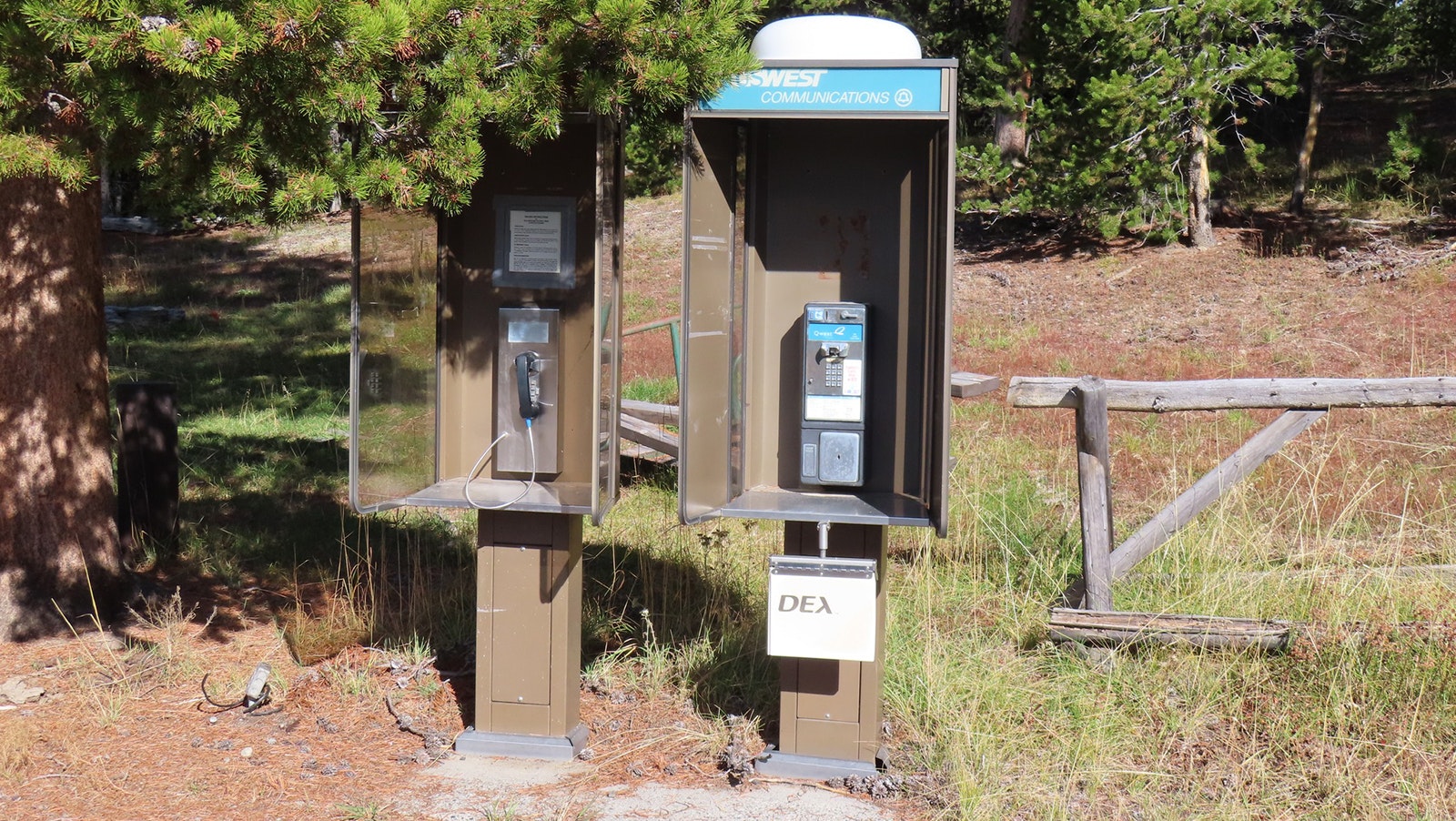Of these two payphones at the Norris Campground in Yellowstone National Park, one still works.